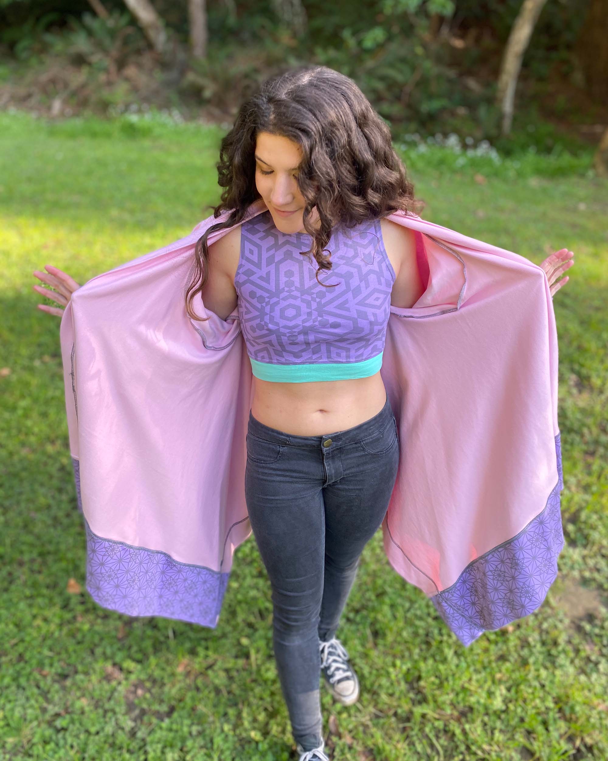 Organic cotton pink kimono with geometric printed lavender fabric accents, front view on female model.