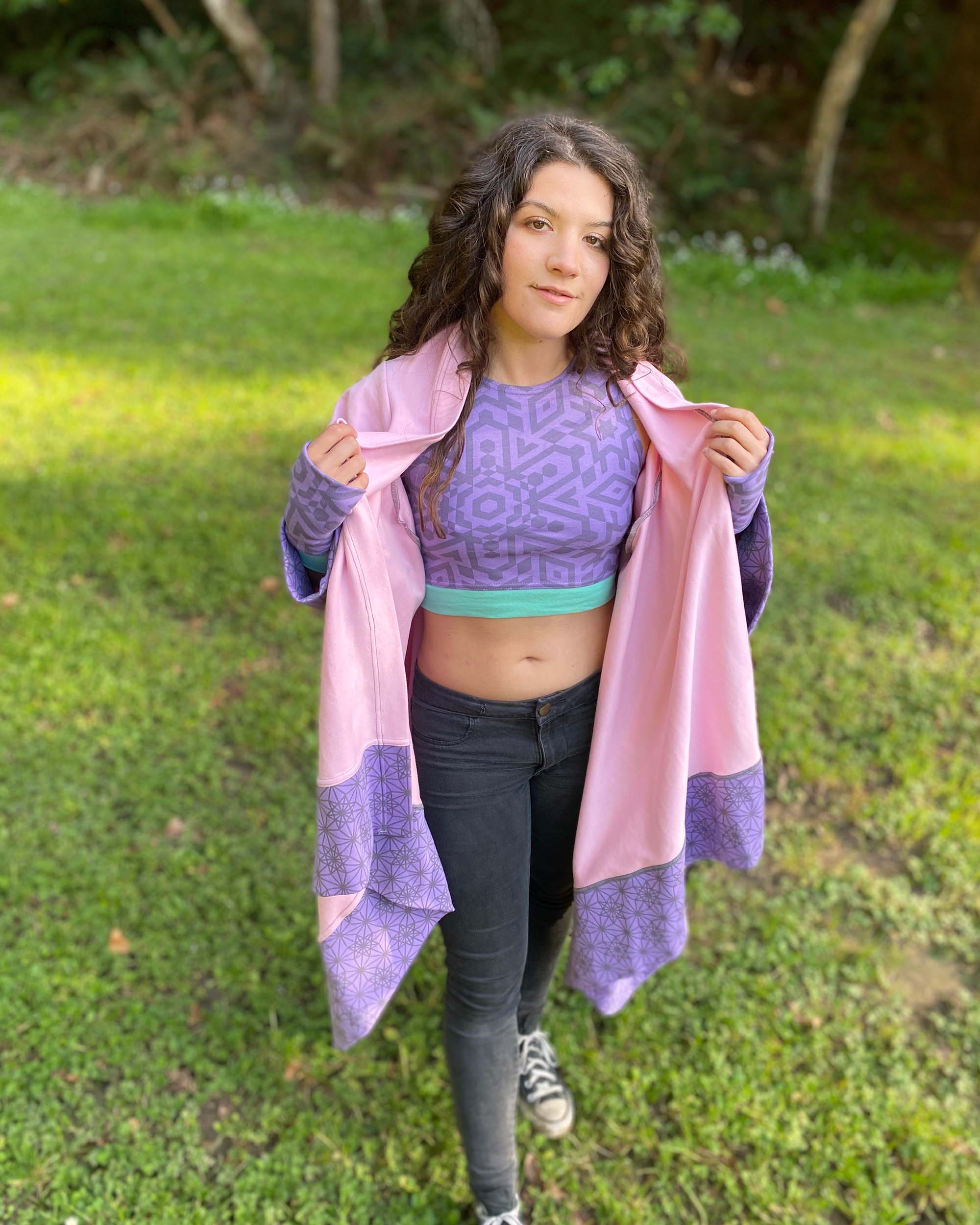 Organic cotton pink kimono with geo print lavender fabric accents, front view on female model.