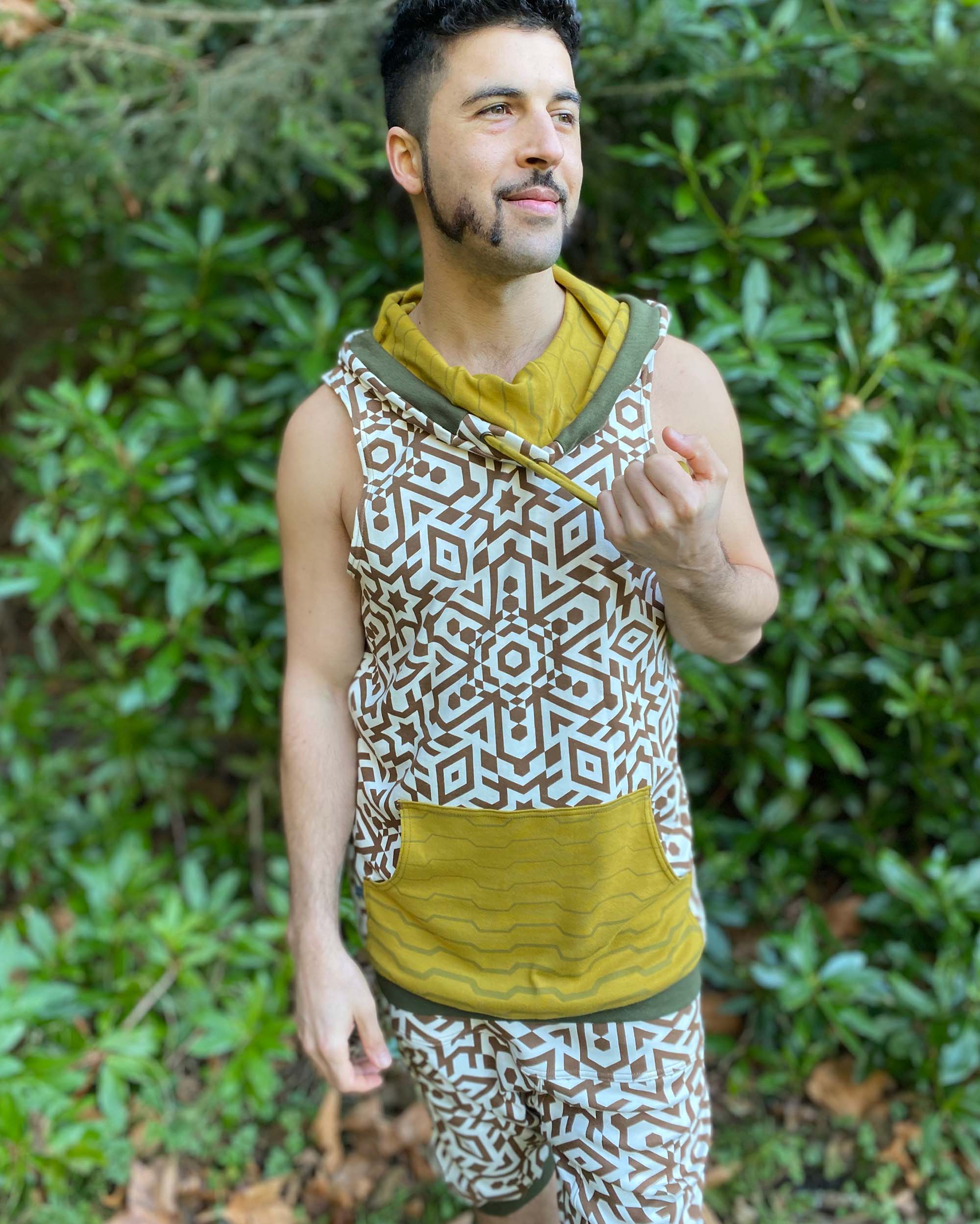 Organic cotton hooded tank top, un-dyed fabric with brown geometric print, front view on male model.