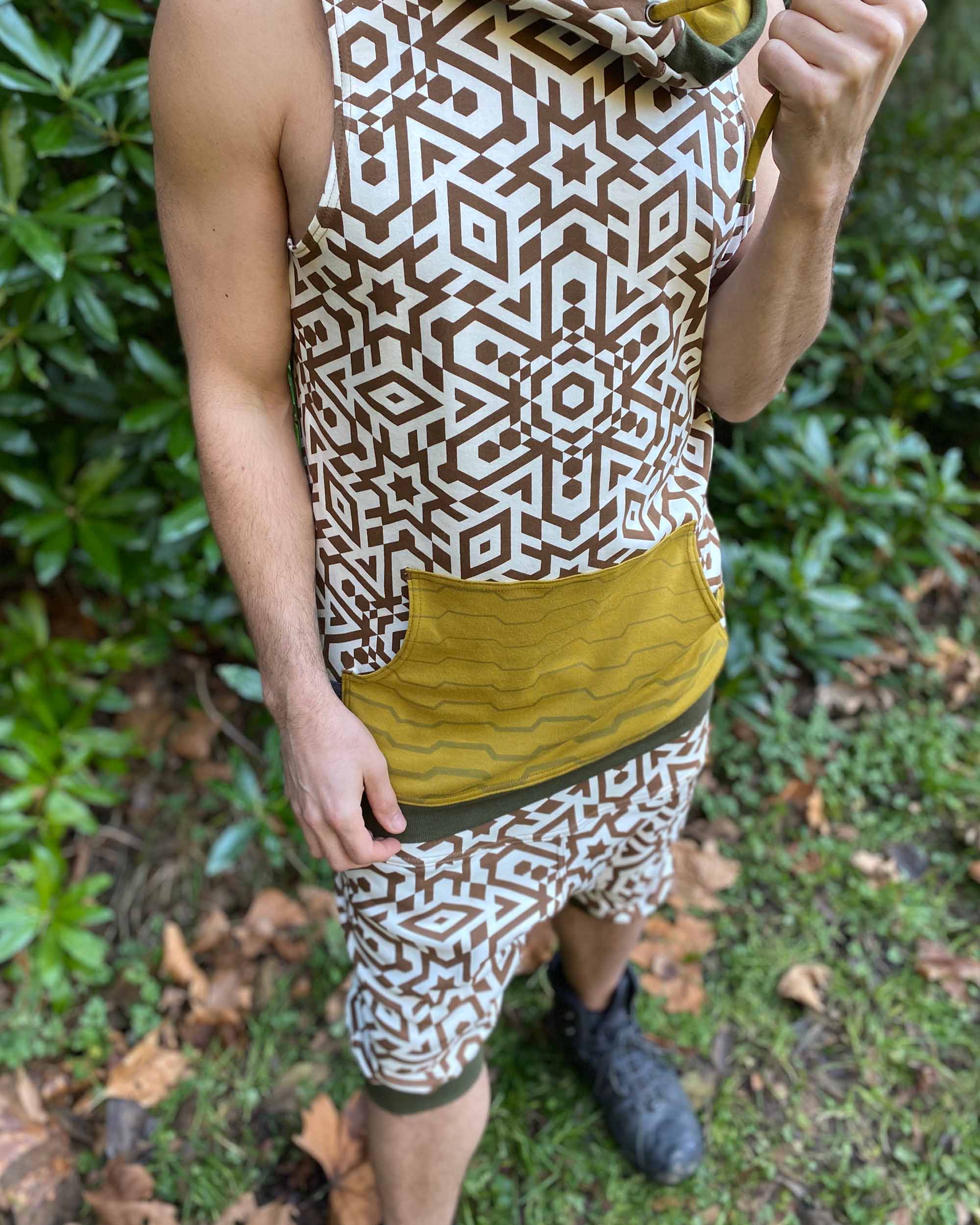 Organic cotton hooded tank top, un-dyed fabric with brown geometric print, detail view of the fabric.