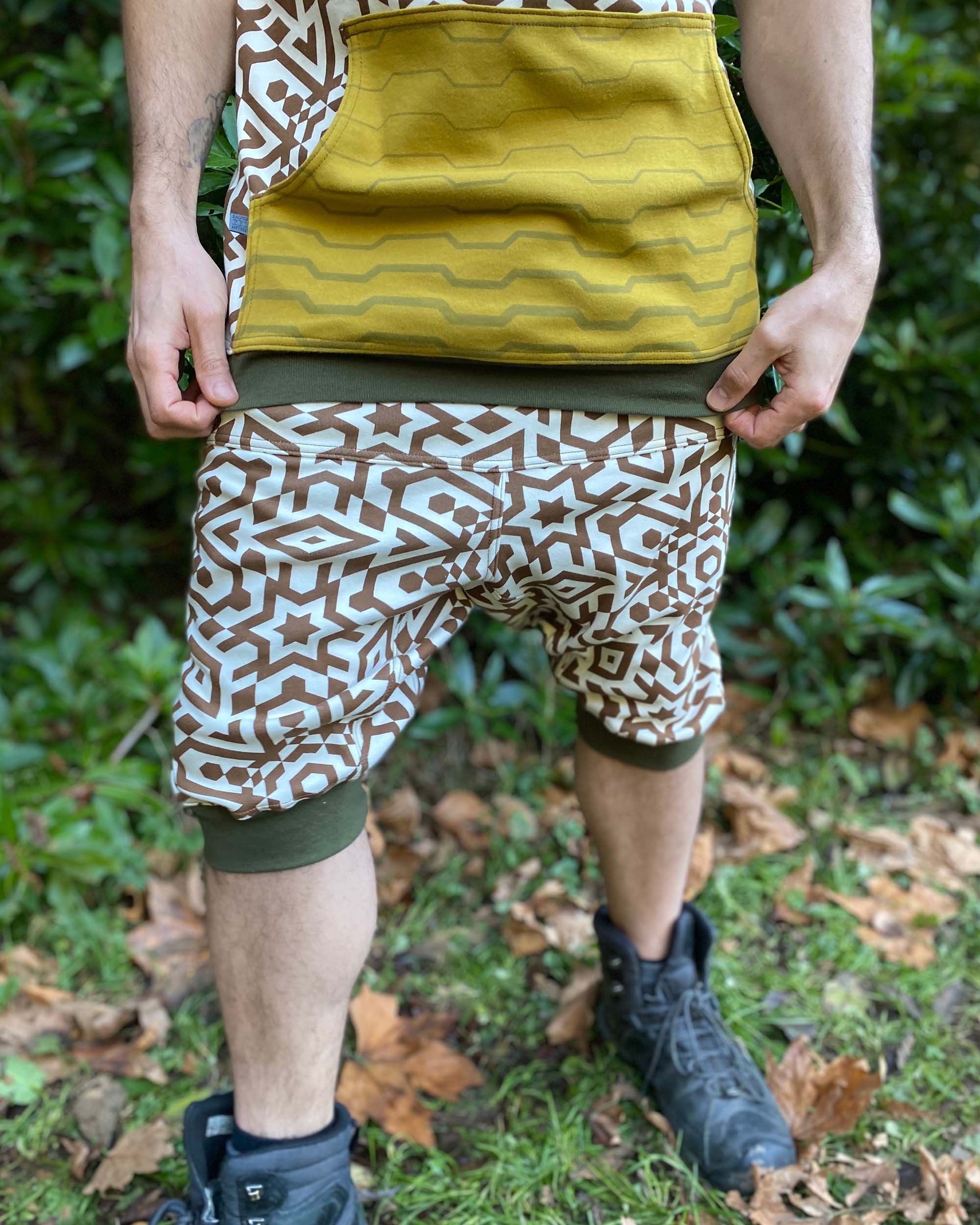 Organic cotton hooded tank top, un-dyed fabric with brown geometric print, detail view of front pocket