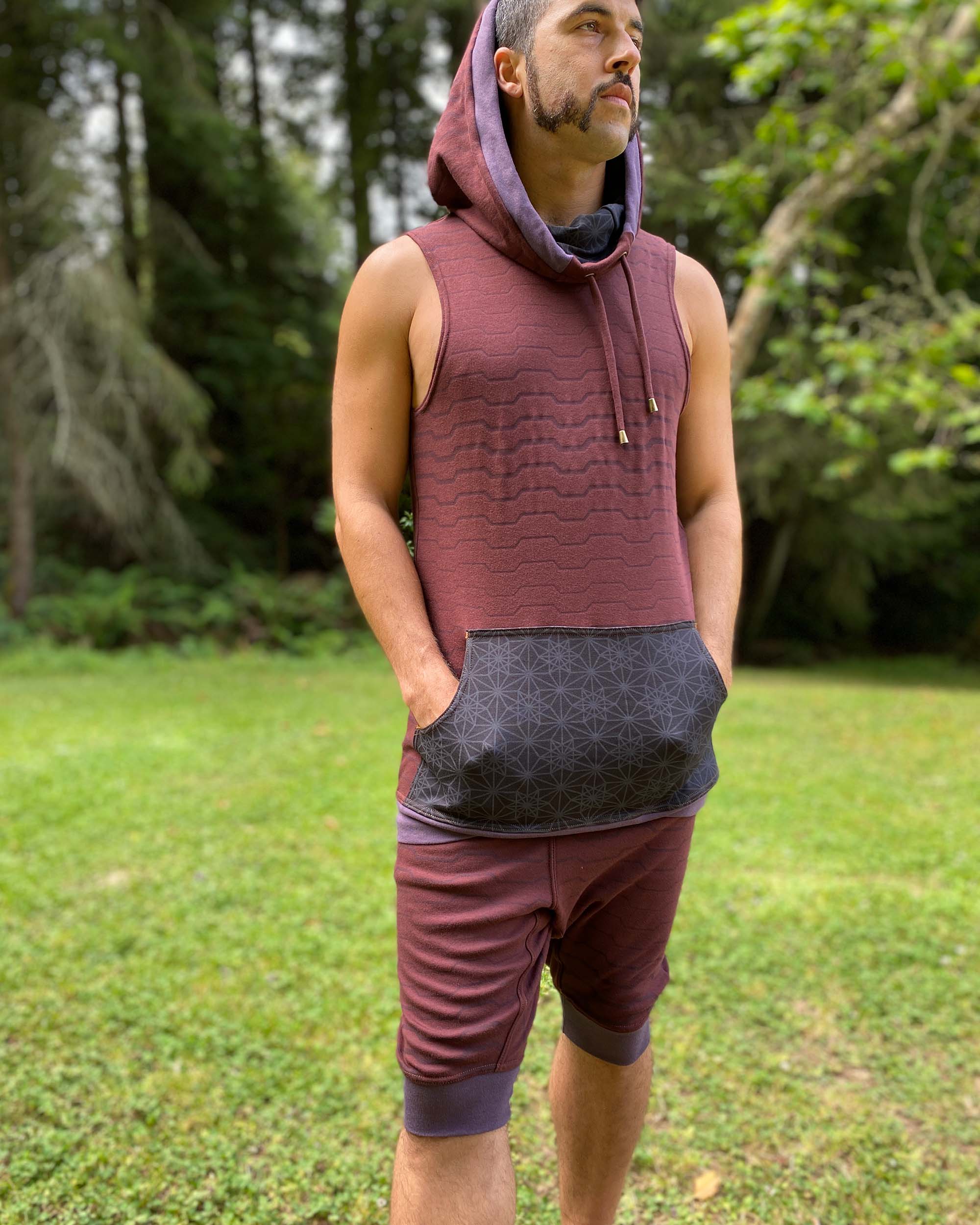 Cowl hood tank top and drop crotch shorts, reddish brown fabric with geometric stripes, front view on model.