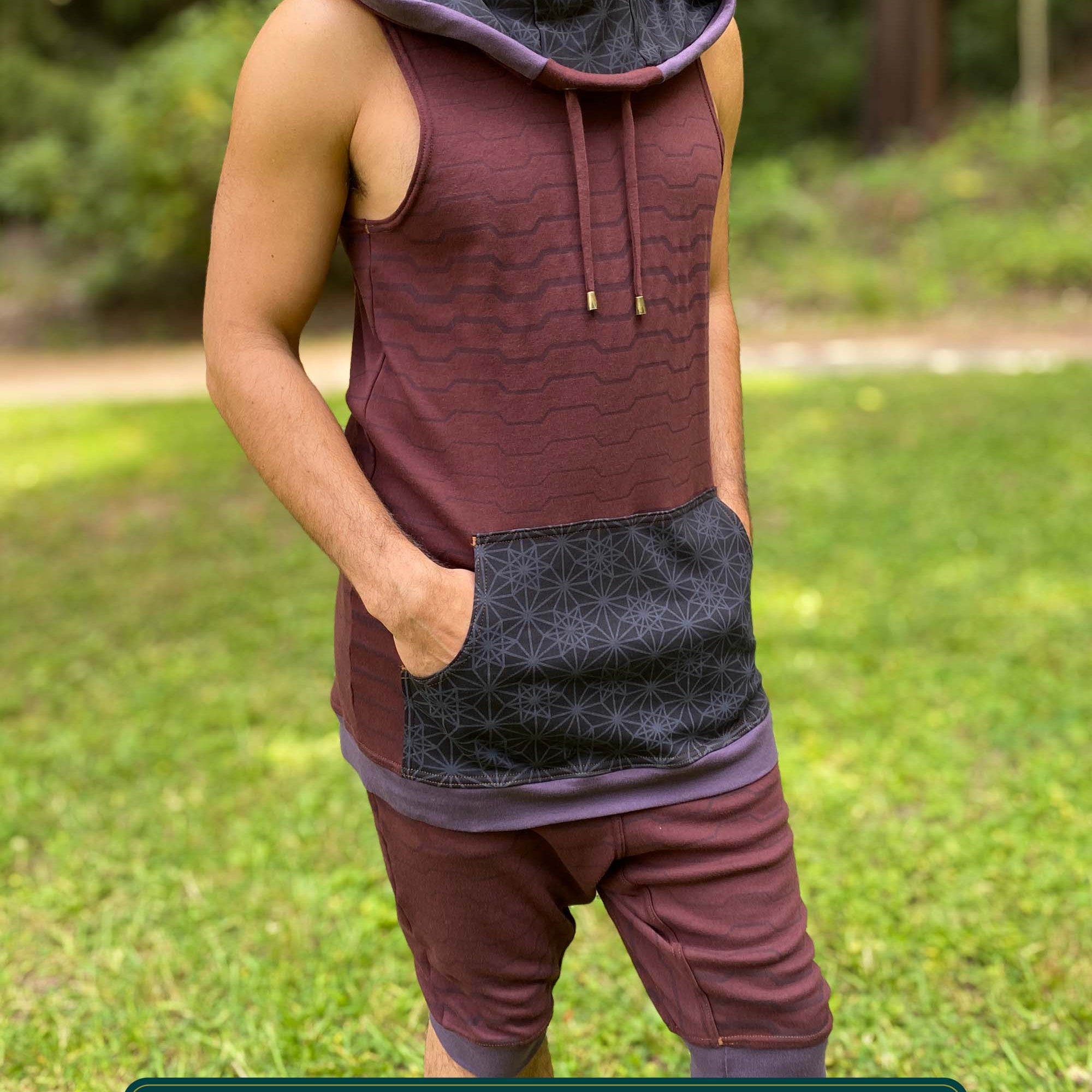 Cowl hood tank top and drop crotch shorts, brown fabric with geometric stripes, front right view on male model.