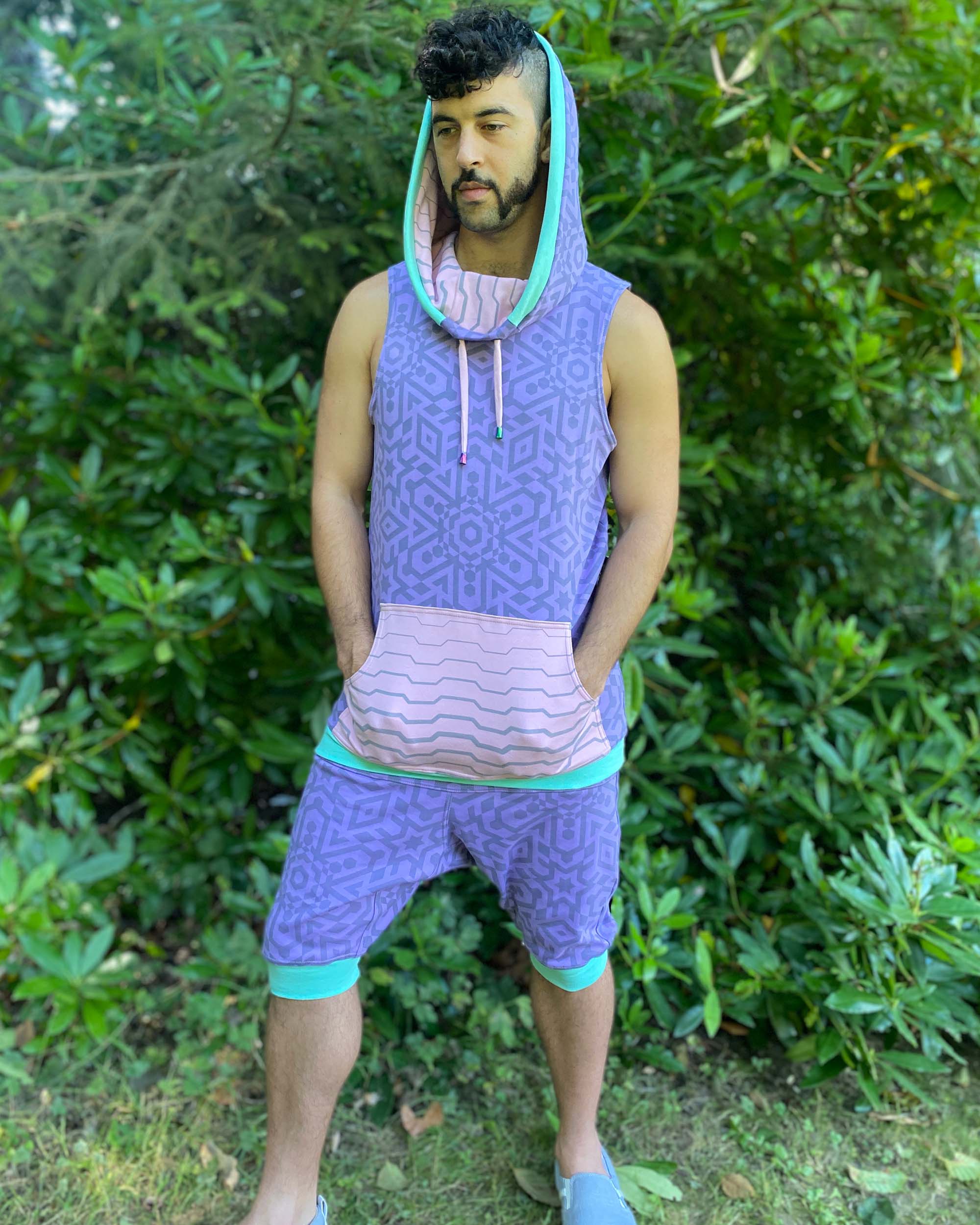 Hooded tank top and drop crotch shorts, lavender fabric with geometric print, full body view on model.