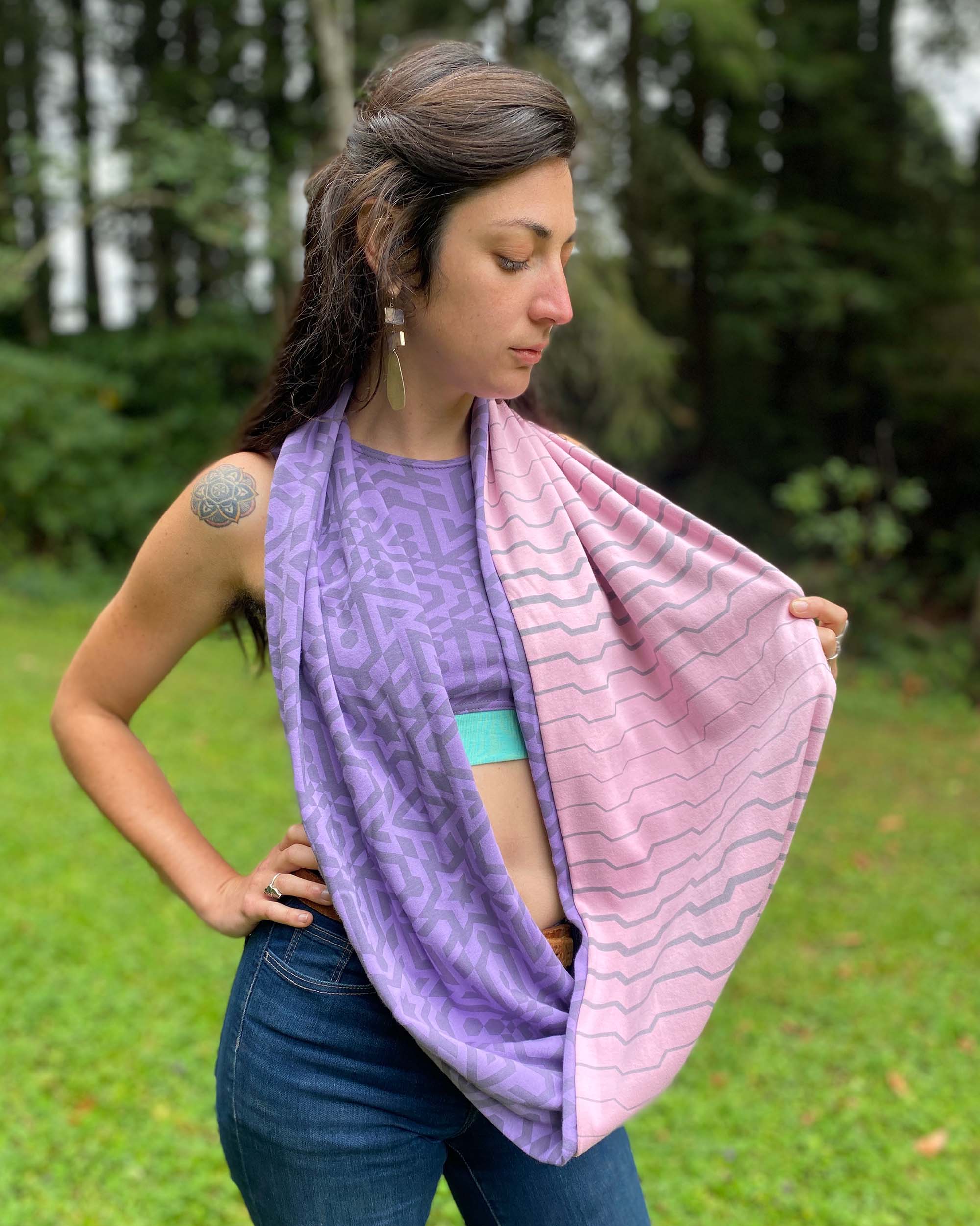 Lavender and pink organic cotton two tone infinity scarf with geometric printed fabric, side view on female model.