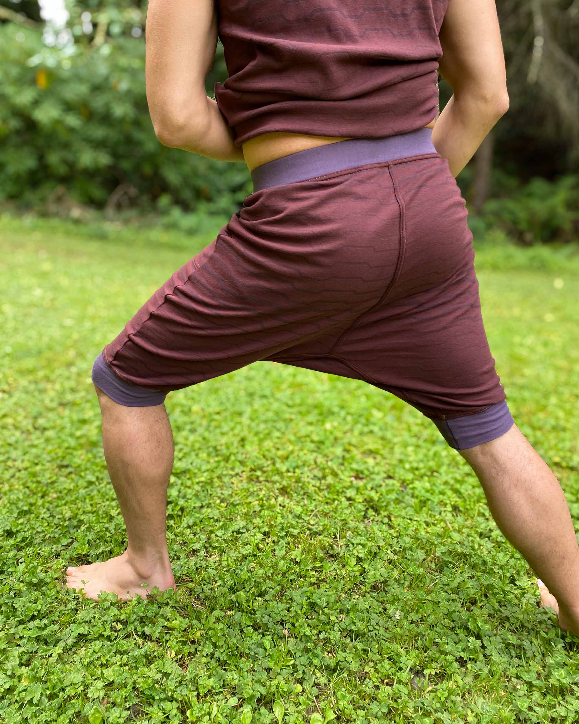 Organic cotton drop crotch shorts, brown fabric with geometric print, back view on male model.