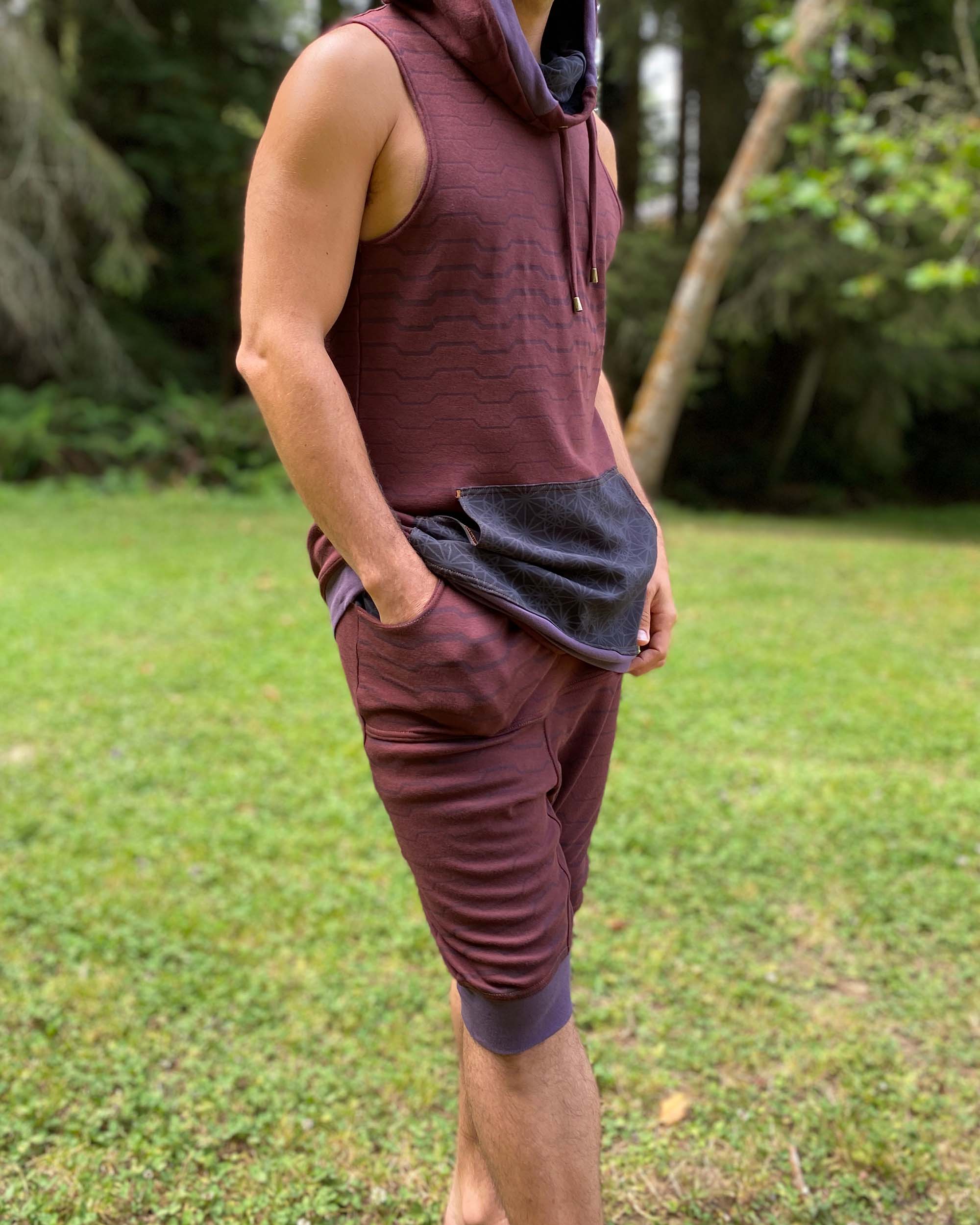 Organic cotton drop crotch shorts, brown fabric with geo print, right side view on male model.