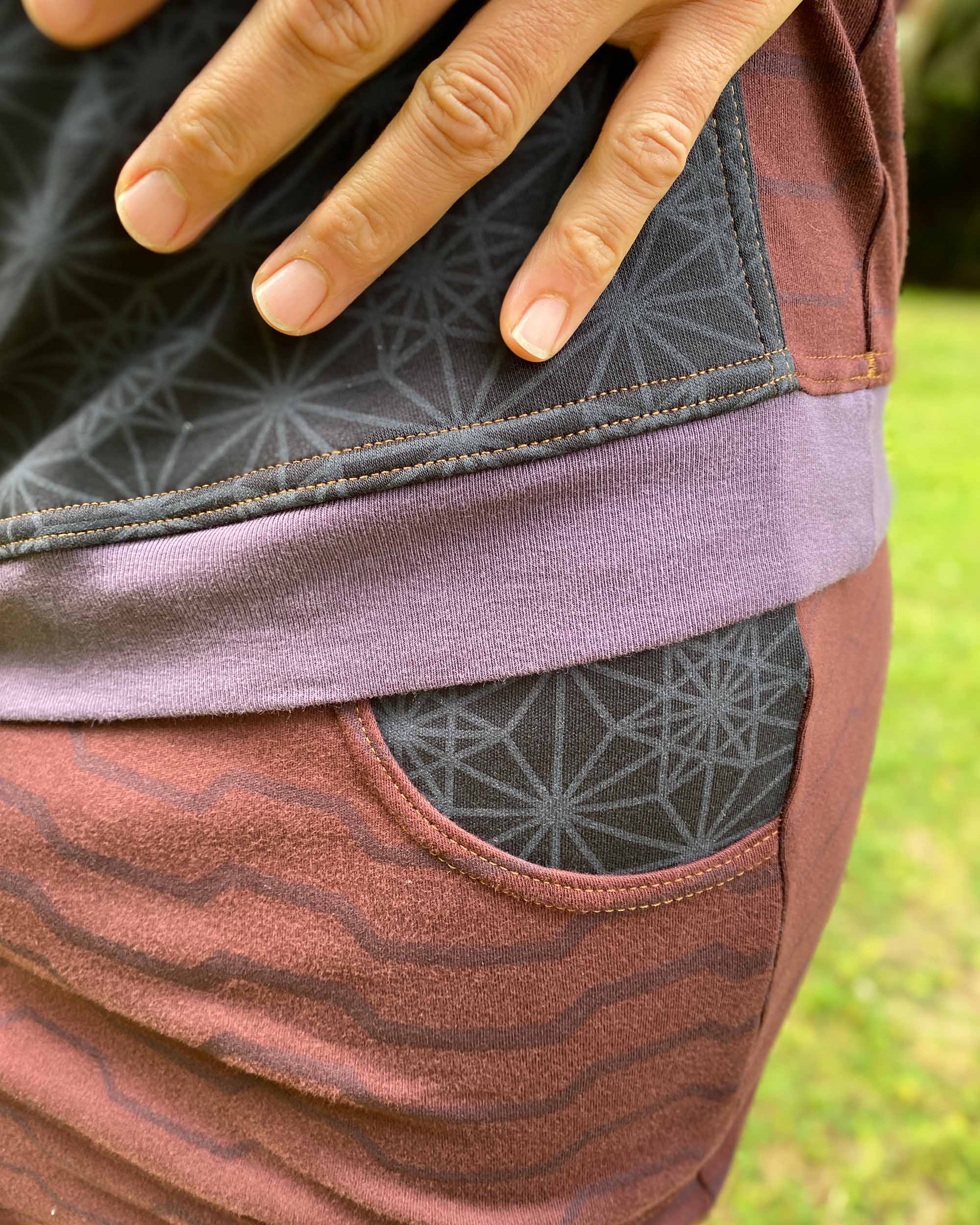 Organic cotton drop crotch shorts, brown fabric with geo print, detail view of fabric.