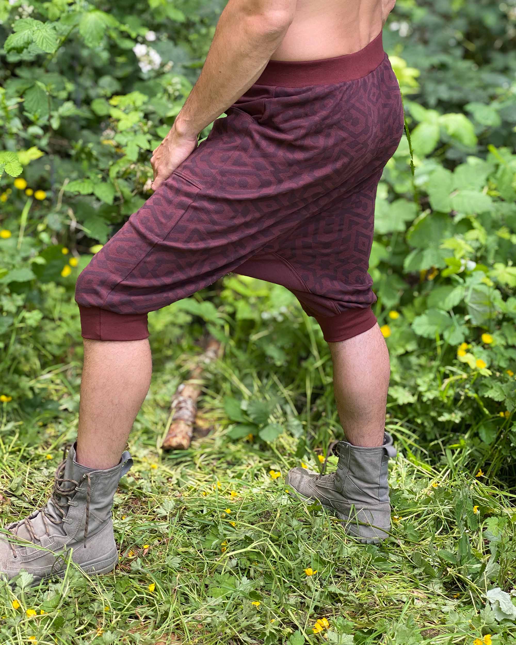 Organic cotton drop crotch shorts, brown fabric with geometric print, left side view on male model.