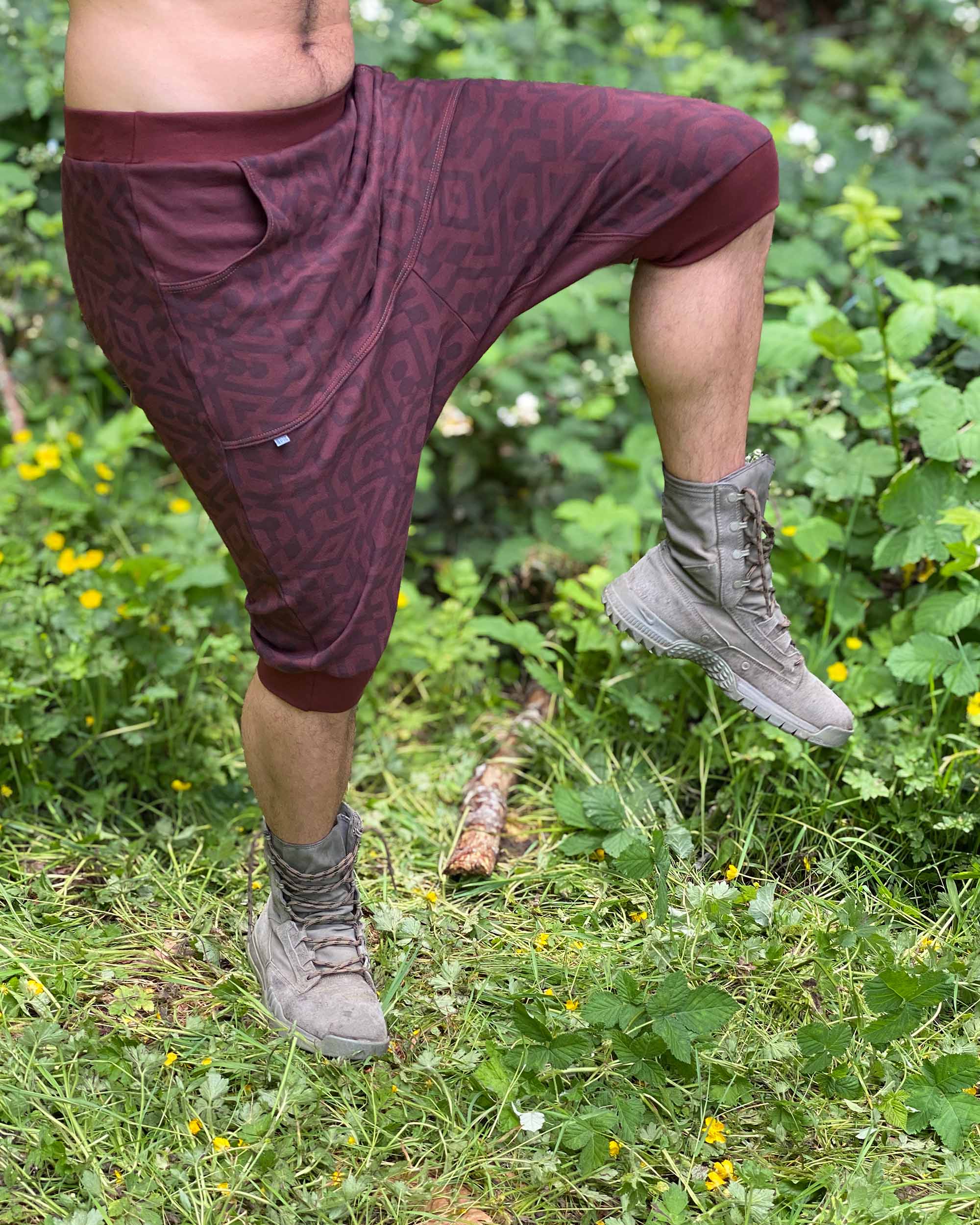 Organic cotton drop crotch shorts, brown fabric with geometric print, right side view on male model.