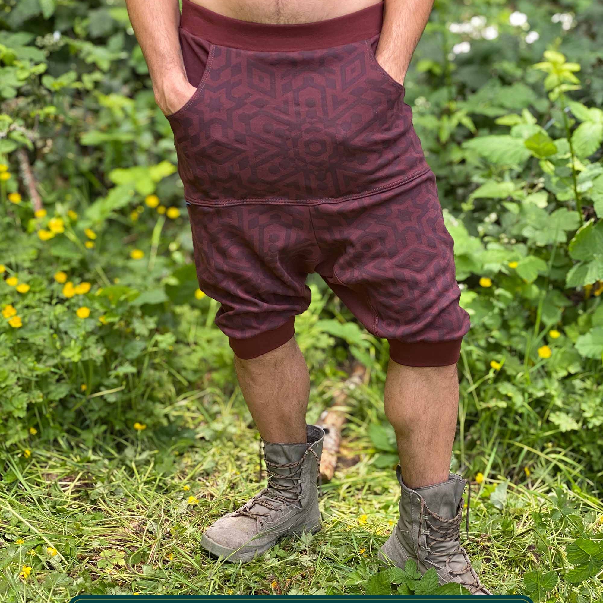 Organic cotton drop crotch shorts, brown fabric with sacred geometry print, front view on male model.