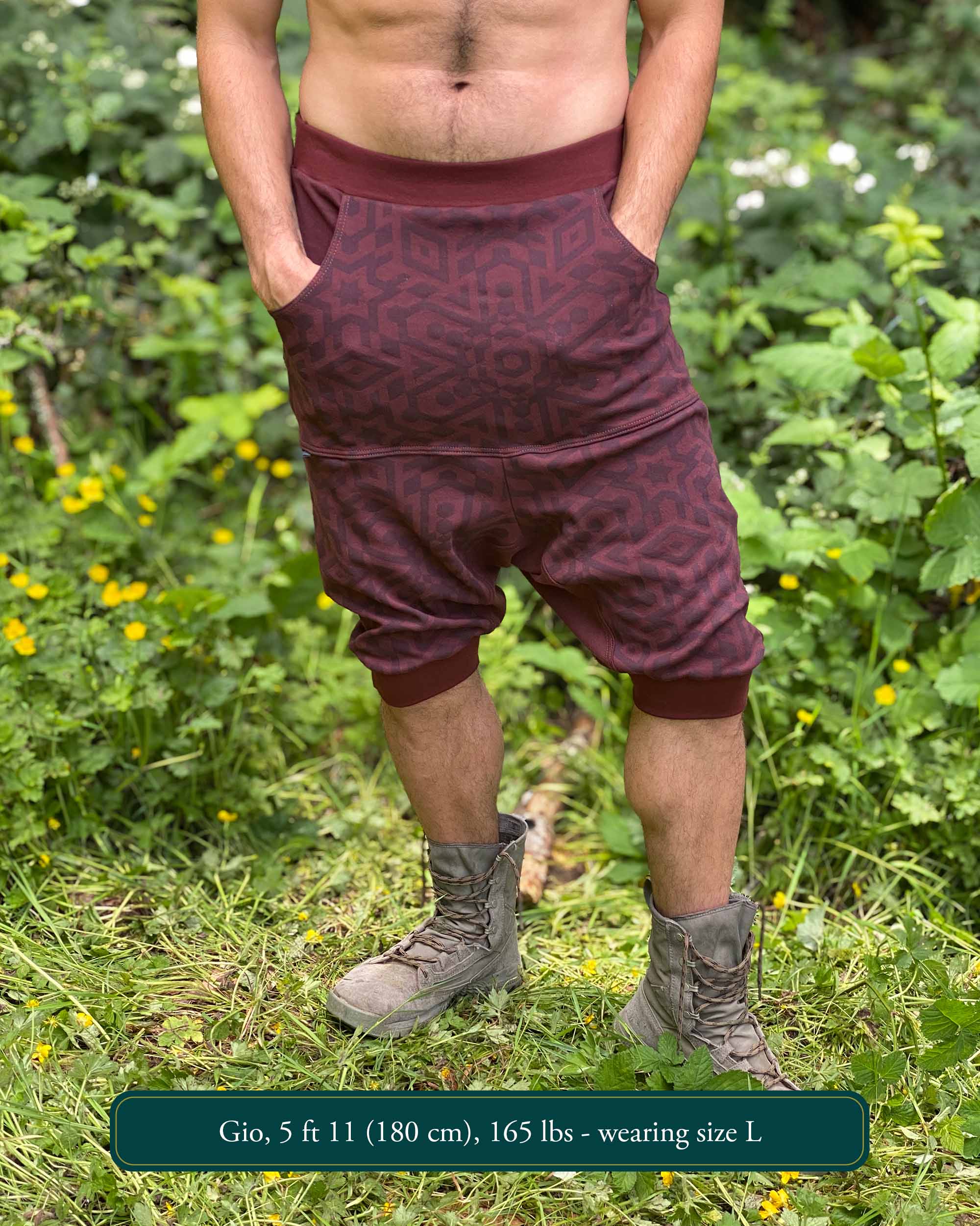 Organic cotton drop crotch shorts, brown fabric with sacred geometry print, front view on male model.