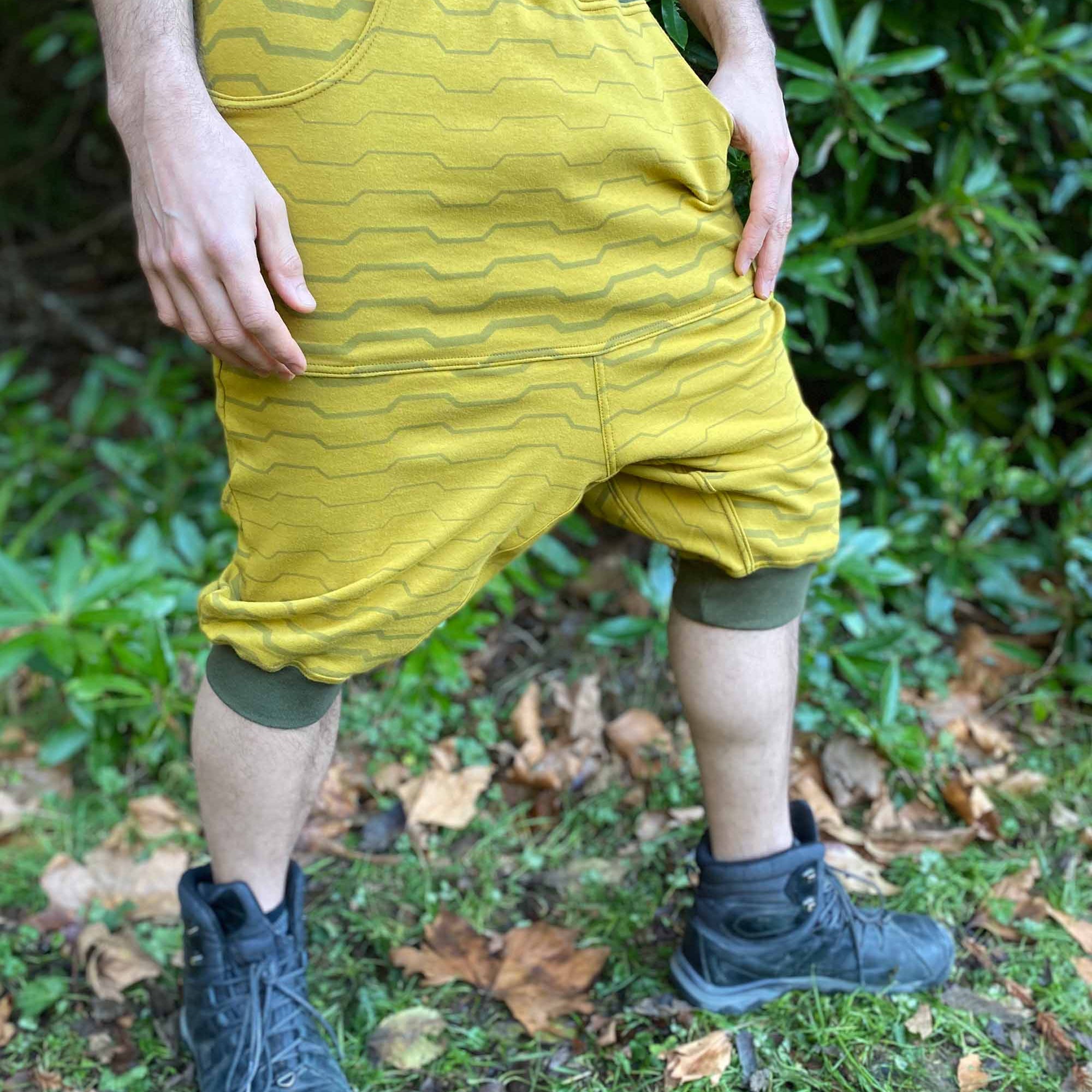 Organic cotton drop crotch shorts, yellow fabric with stripe print, right side view on male model.