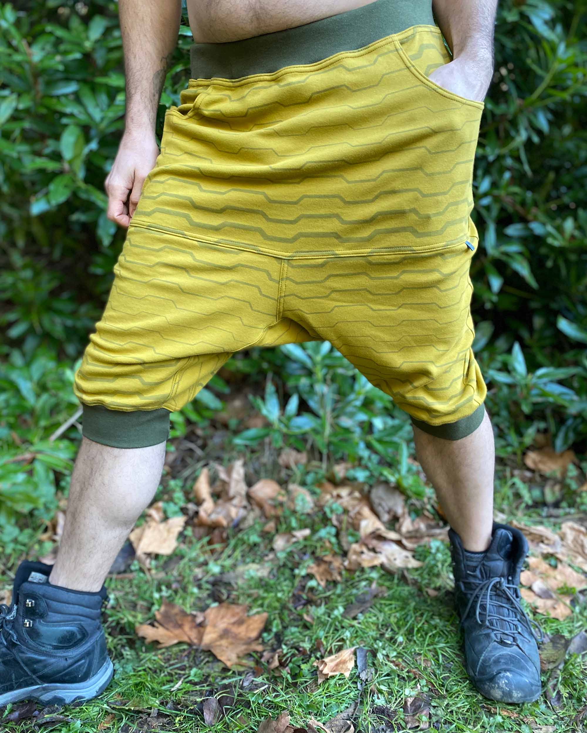 Organic cotton drop crotch shorts, yellow fabric with stripe print, front side view on male model.