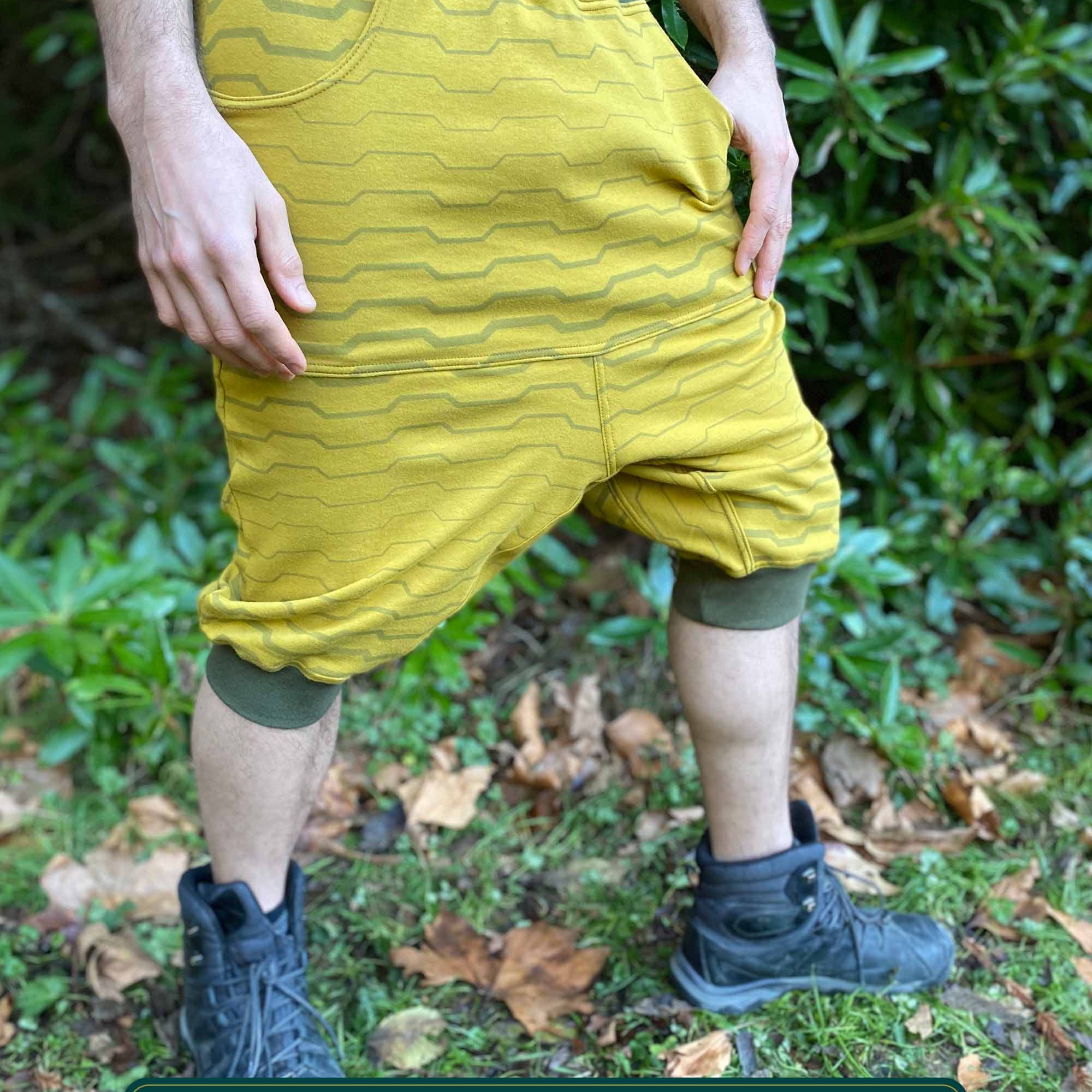 Organic cotton drop crotch shorts, yellow fabric with geometric stripes, right side view on model.
