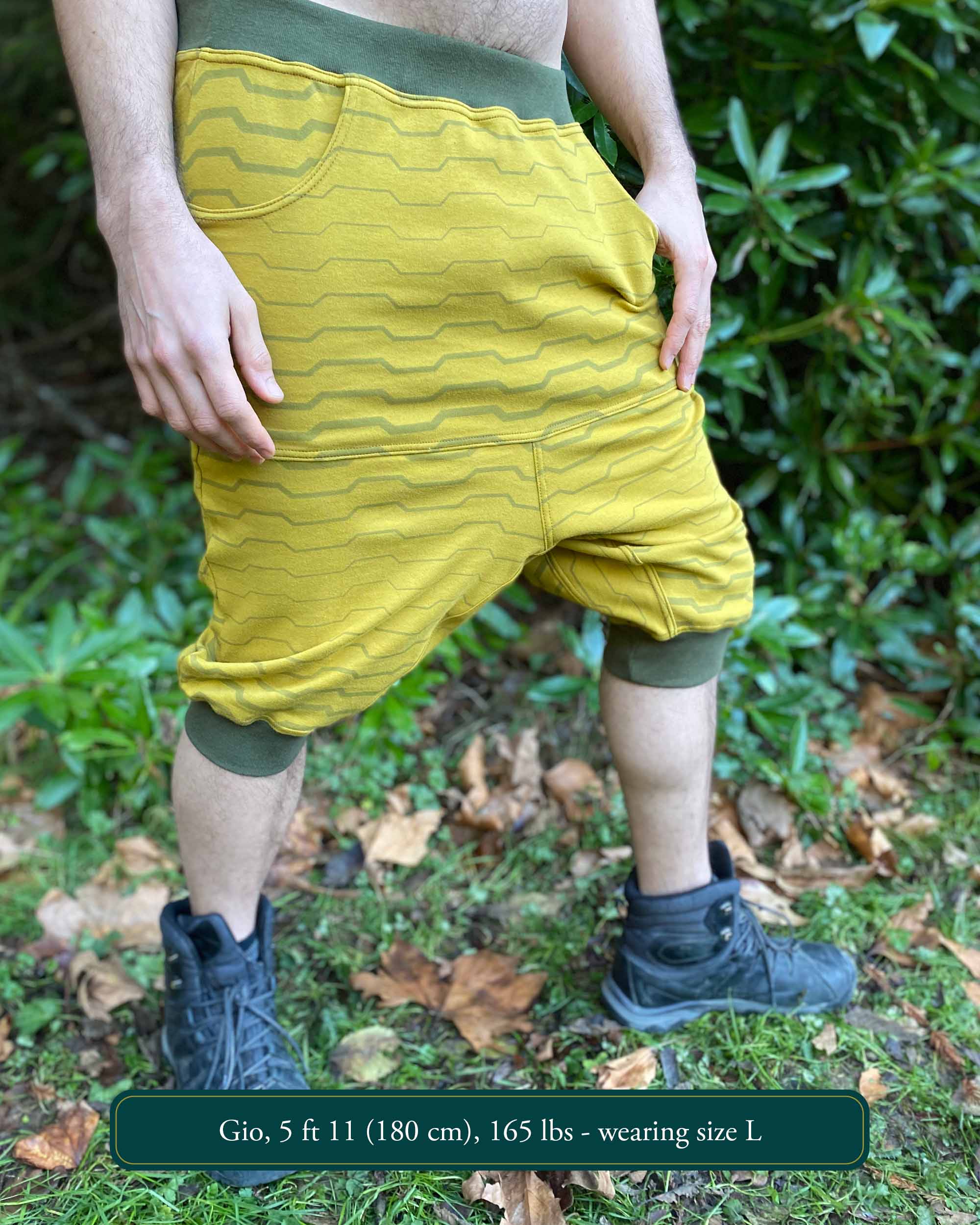 Organic cotton drop crotch shorts, yellow fabric with geometric stripes, right side view on model.