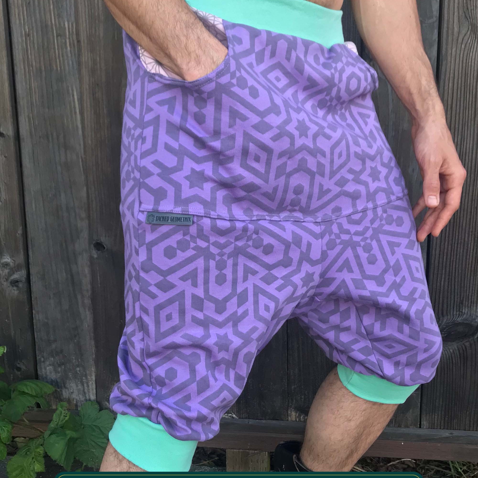 Organic cotton drop crotch shorts, lavender fabric with sacred geometry print, front view on model.