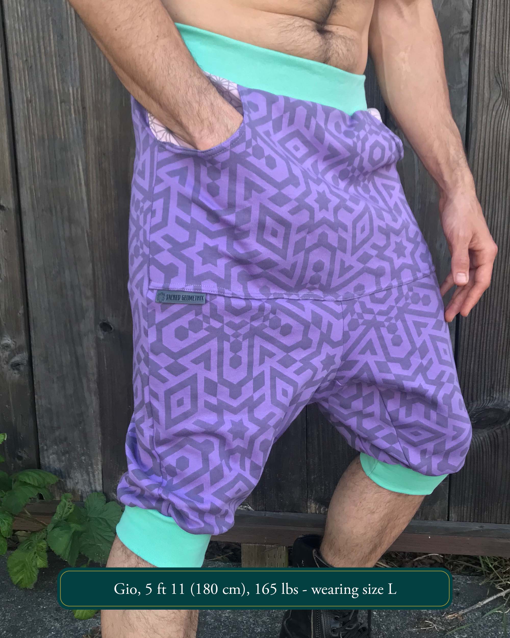 Organic cotton drop crotch shorts, lavender fabric with sacred geometry print, front view on model.