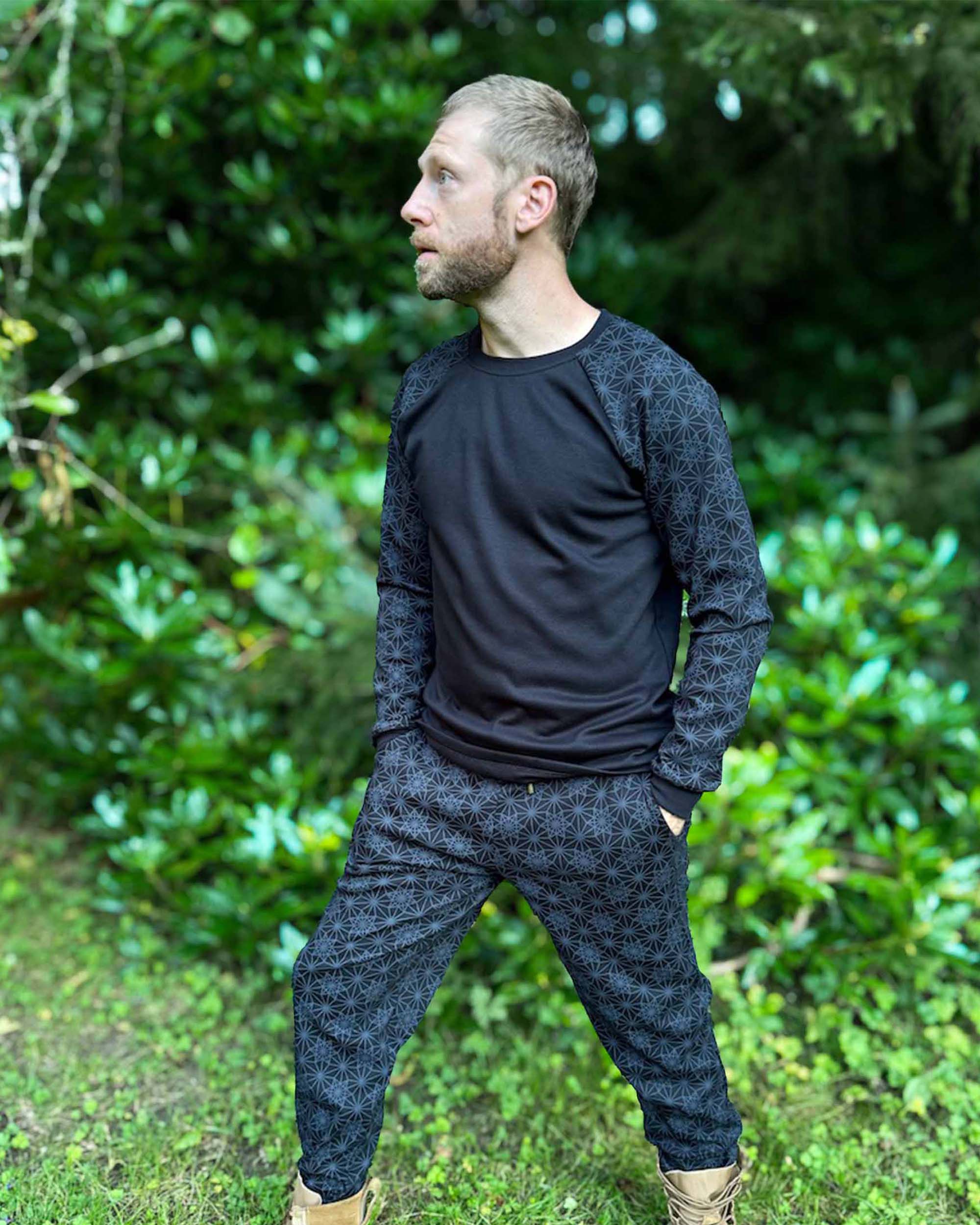 Organic cotton long sleeve shirt, black with geo print accents, front right side view on male model.