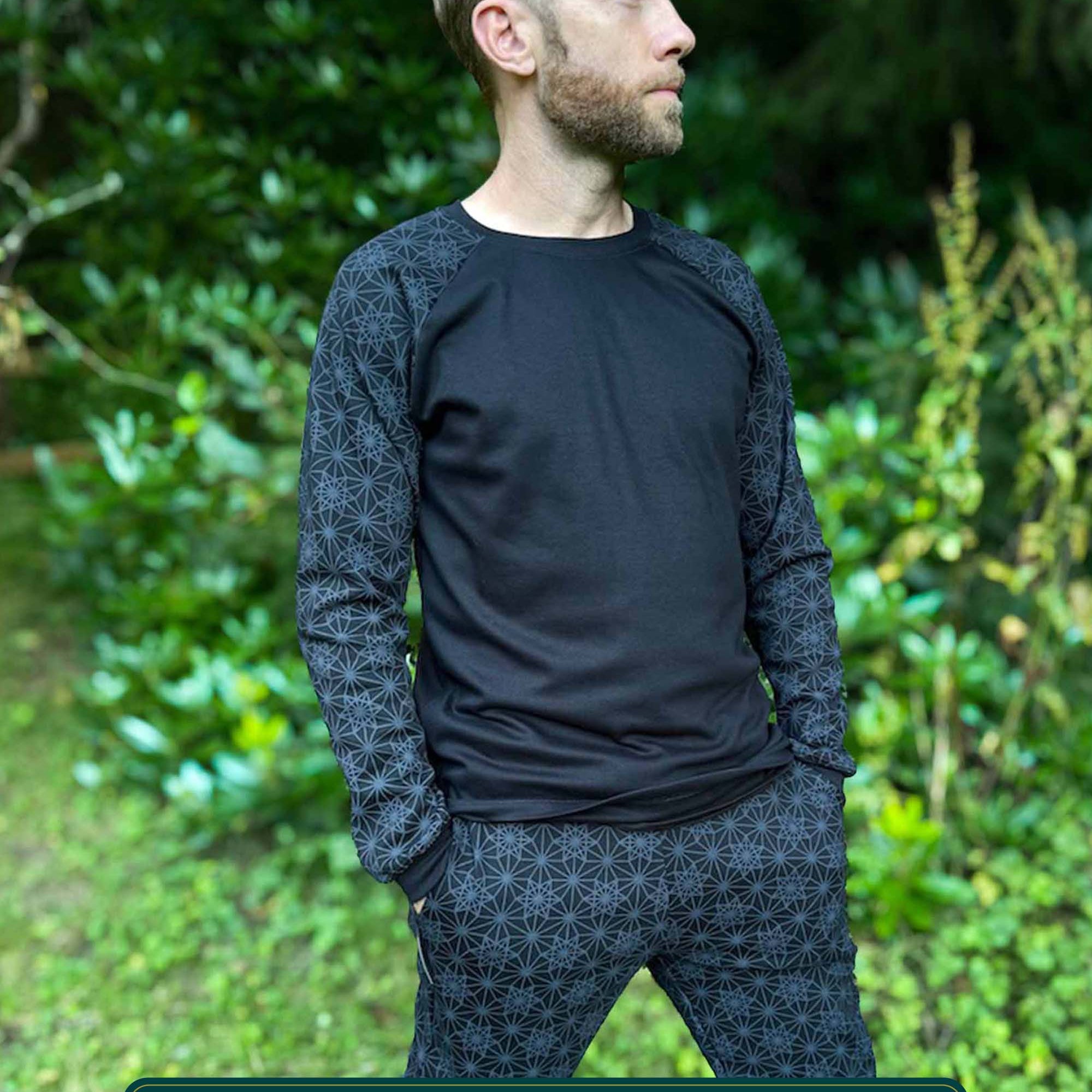 Organic cotton long sleeve shirt, black with geometric sleeve prints, front right side view on male model.