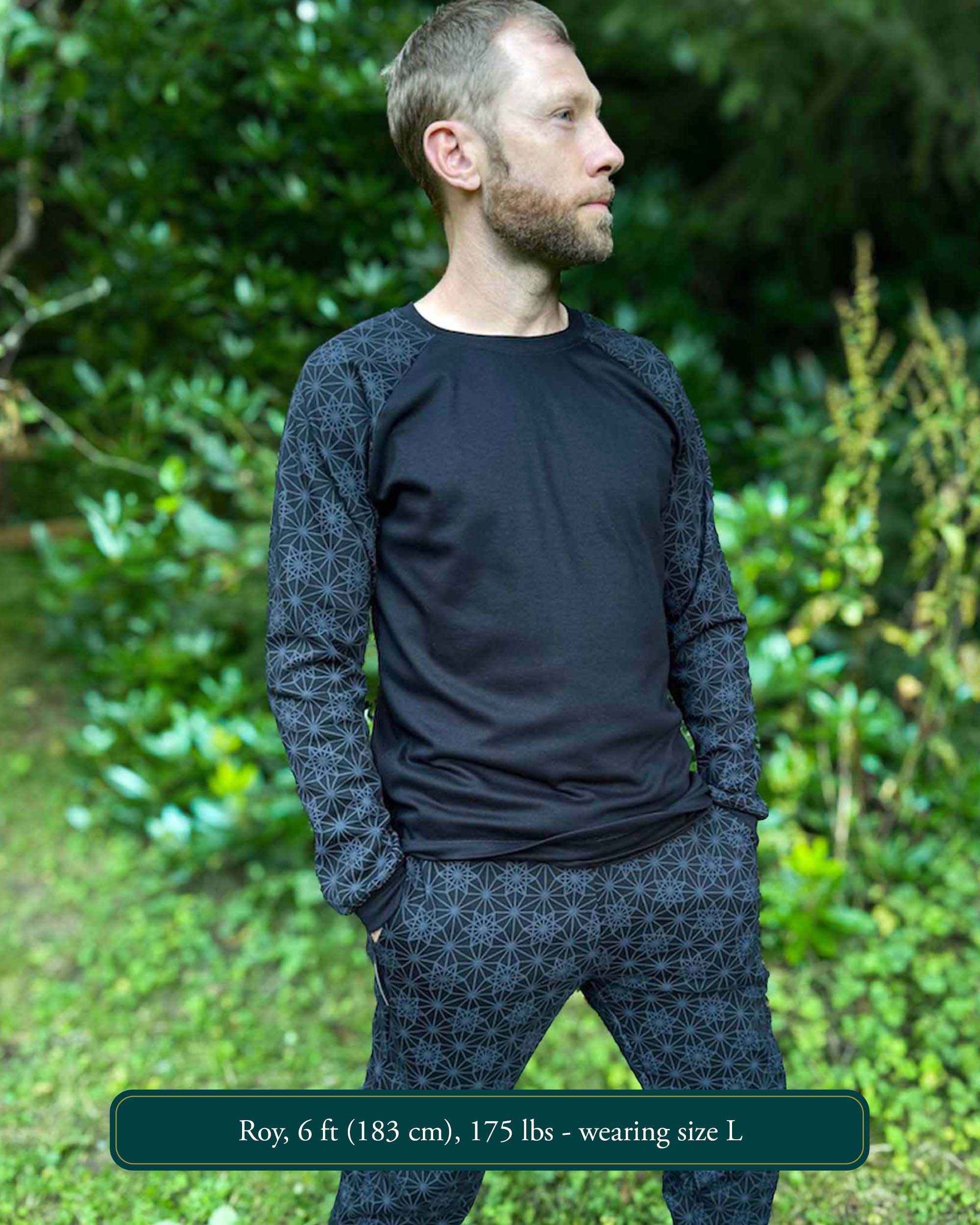 Organic cotton long sleeve shirt, black with geometric sleeve prints, front right side view on male model.