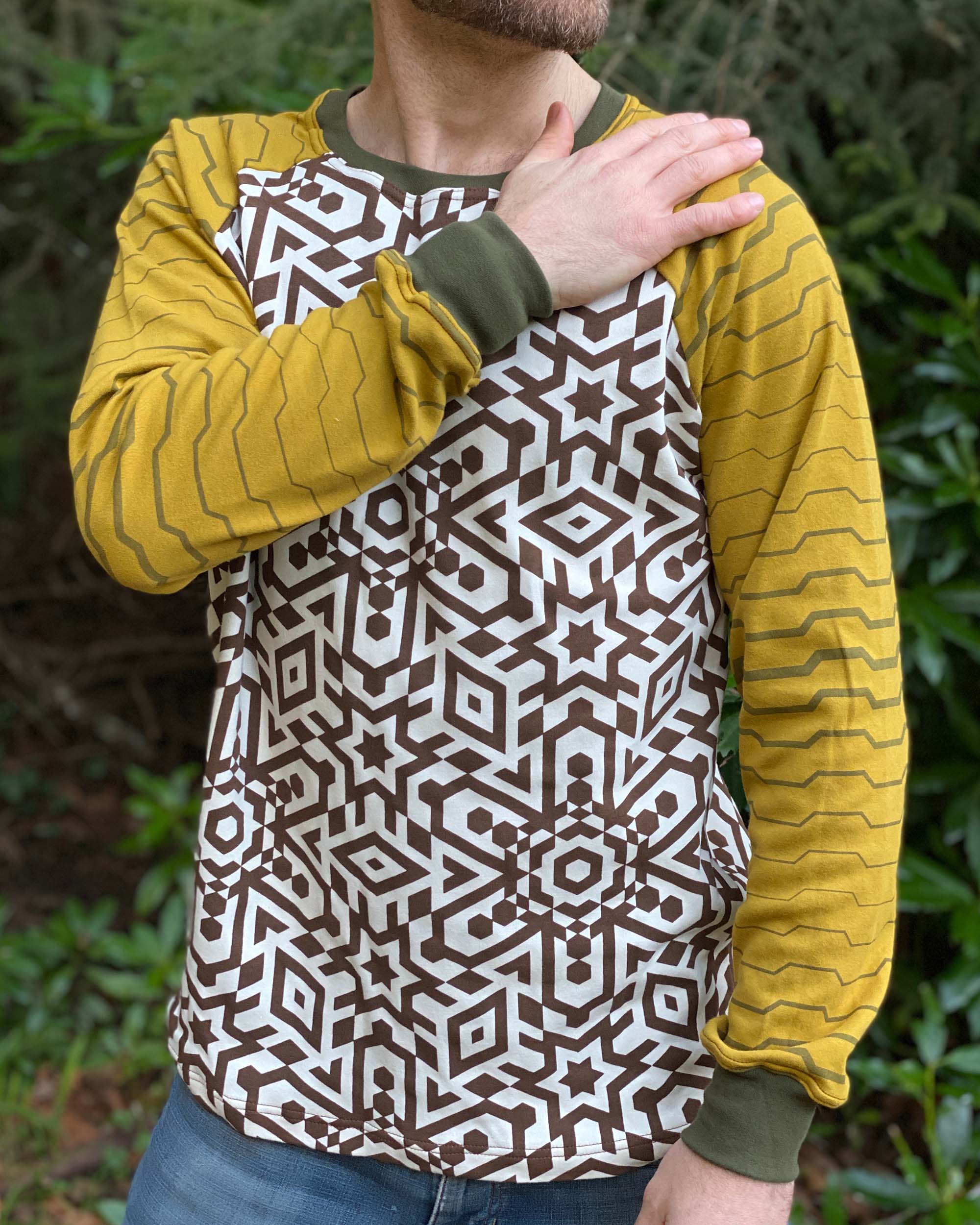 Organic cotton long sleeve shirt, undyed torso with yellow geometric striped sleeves, detail view of fabric.