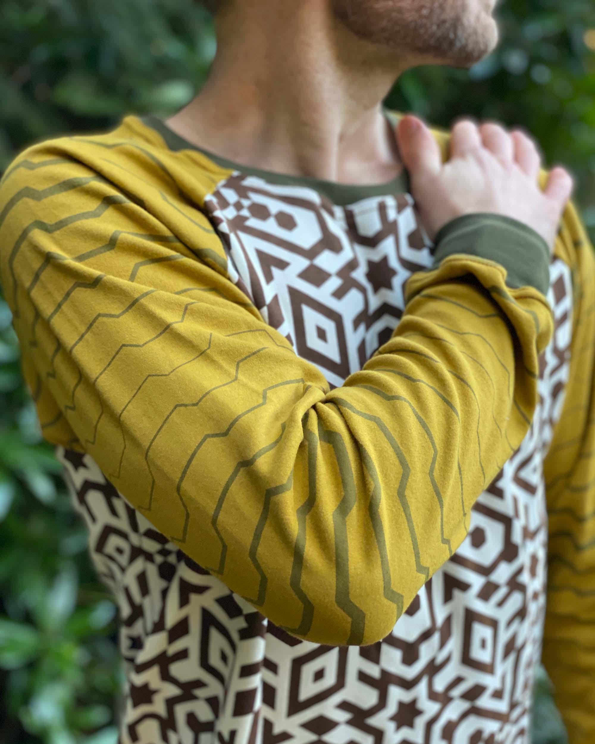 Organic cotton long sleeve shirt, undyed torso with yellow geometric striped sleeves, detail view of sleeve.