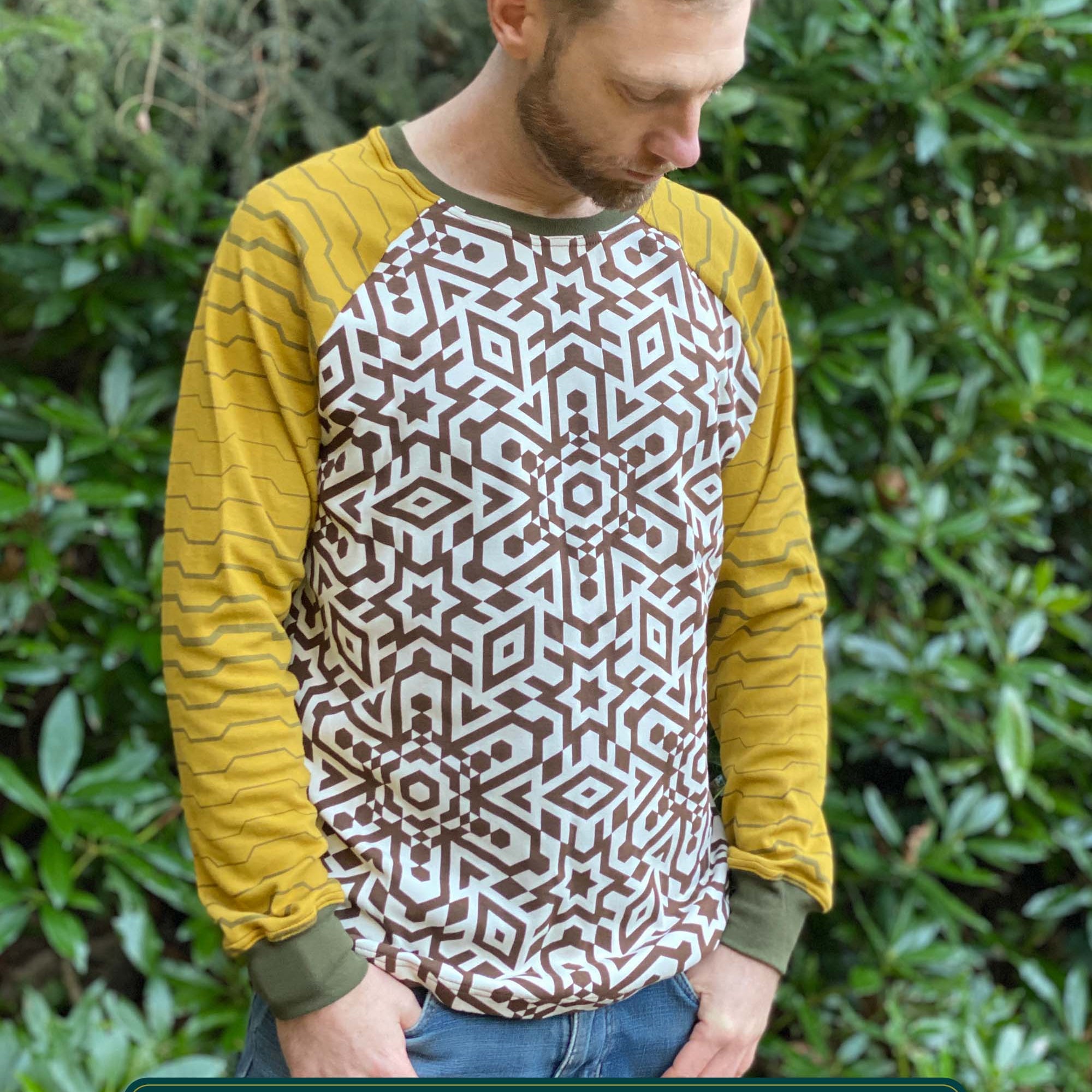 Organic cotton long sleeve shirt, undyed torso with yellow geometric striped sleeves, front view on model.