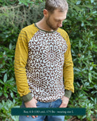 Organic cotton long sleeve shirt, undyed torso with yellow geometric striped sleeves, front view on model.