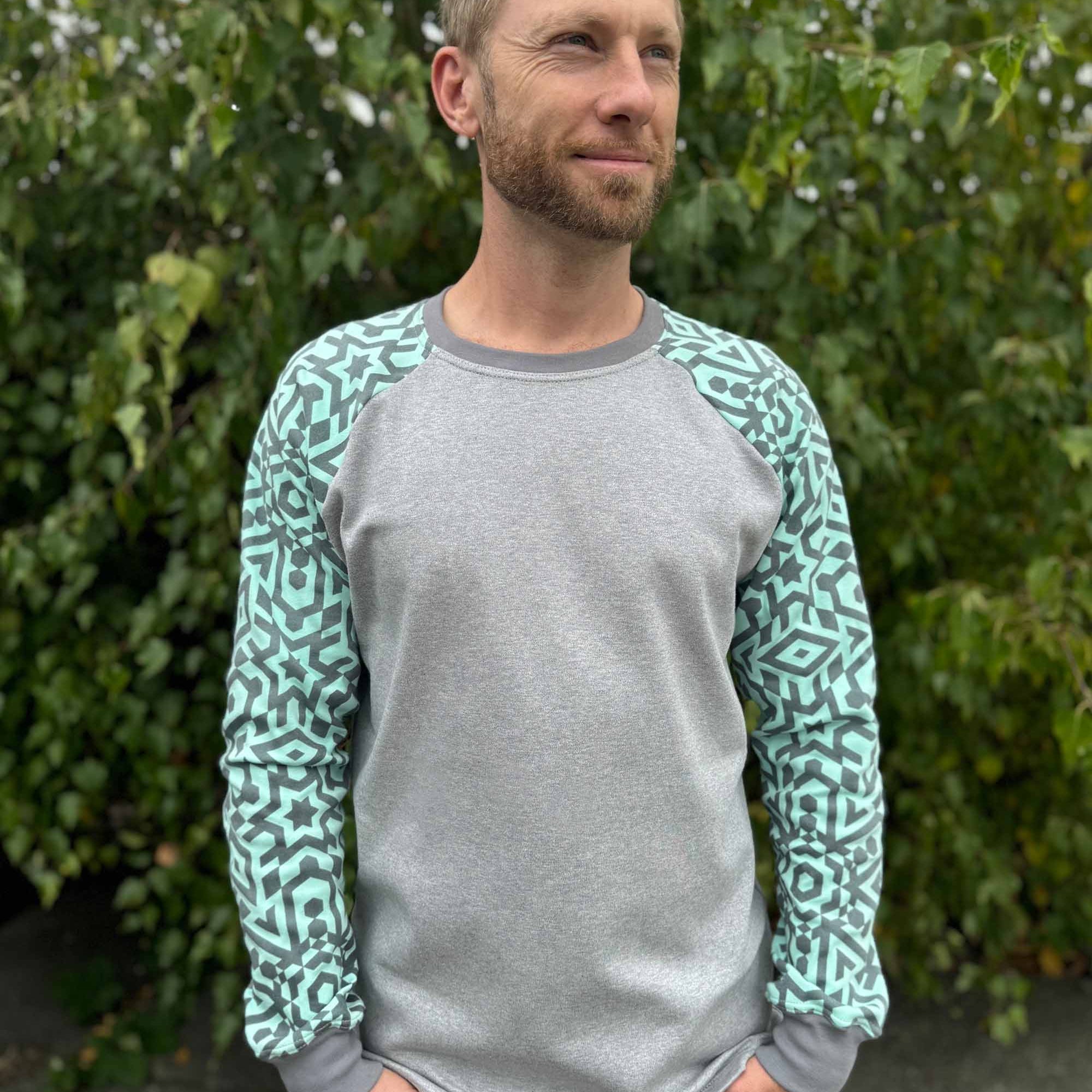 Organic cotton long sleeve shirt, grey with mint geometric sleeves, front view on male model.