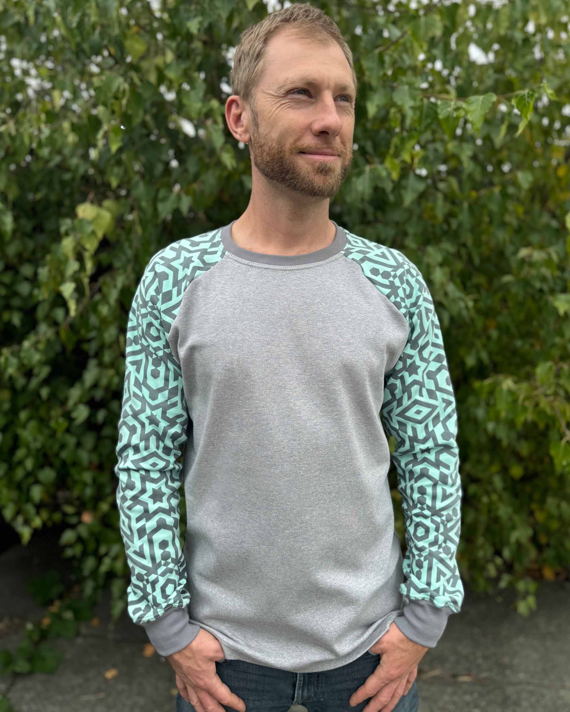 Organic cotton long sleeve shirt, grey with mint geometric sleeves, front view on male model.
