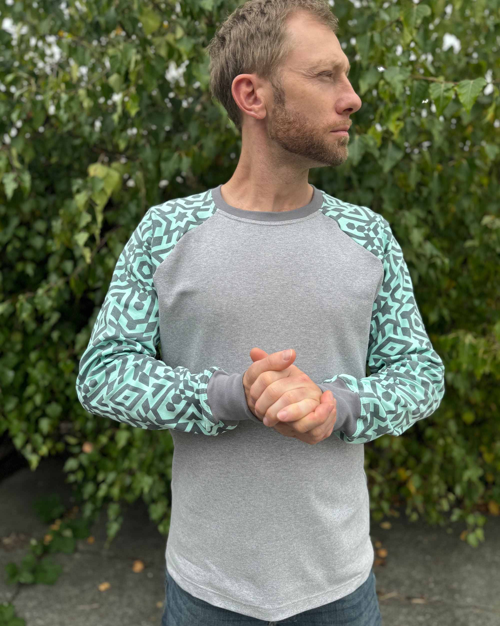 Organic cotton long sleeve shirt, grey with mint sleeves, front view on male model.