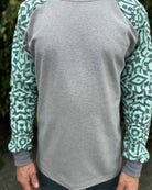Organic cotton long sleeve shirt, grey with mint geometric sleeves, detail view of fabric.