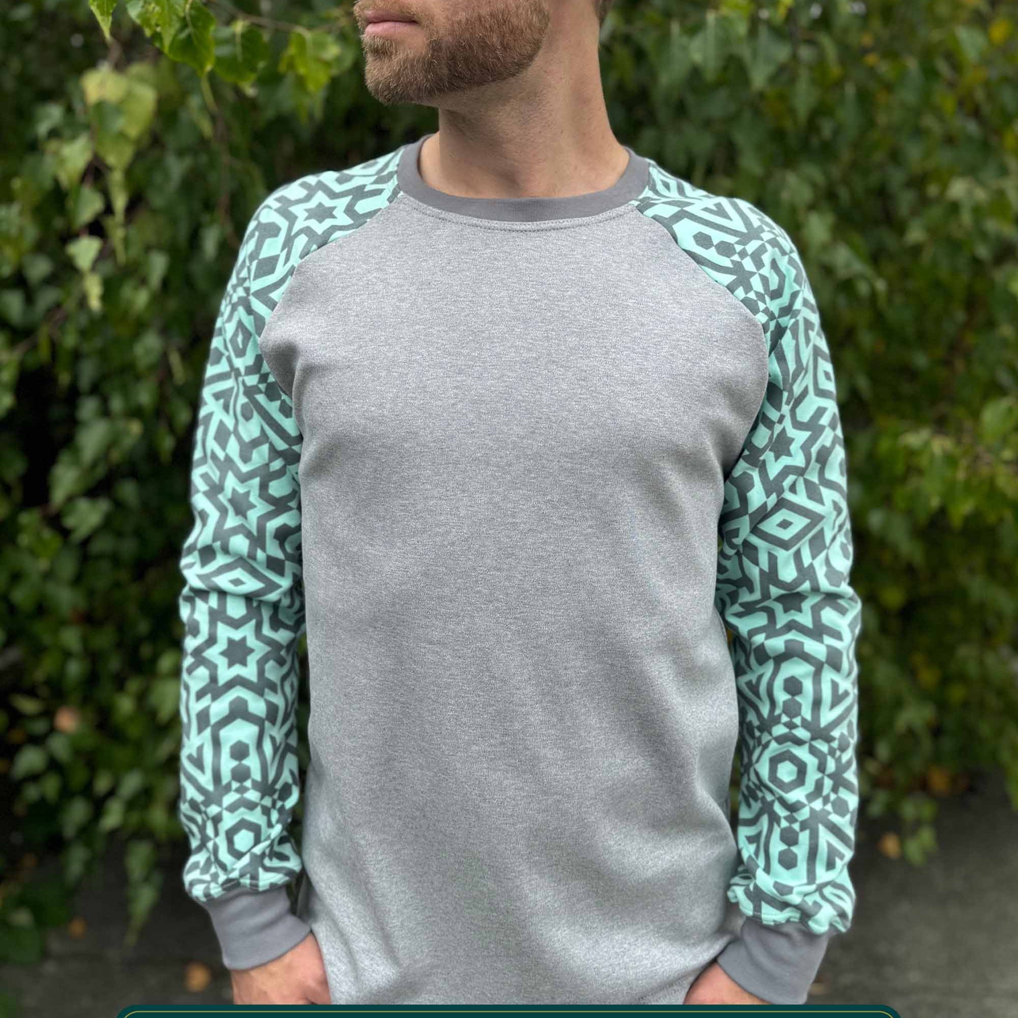 Organic cotton long sleeve shirt, grey with mint geometric sleeves, front view on model.