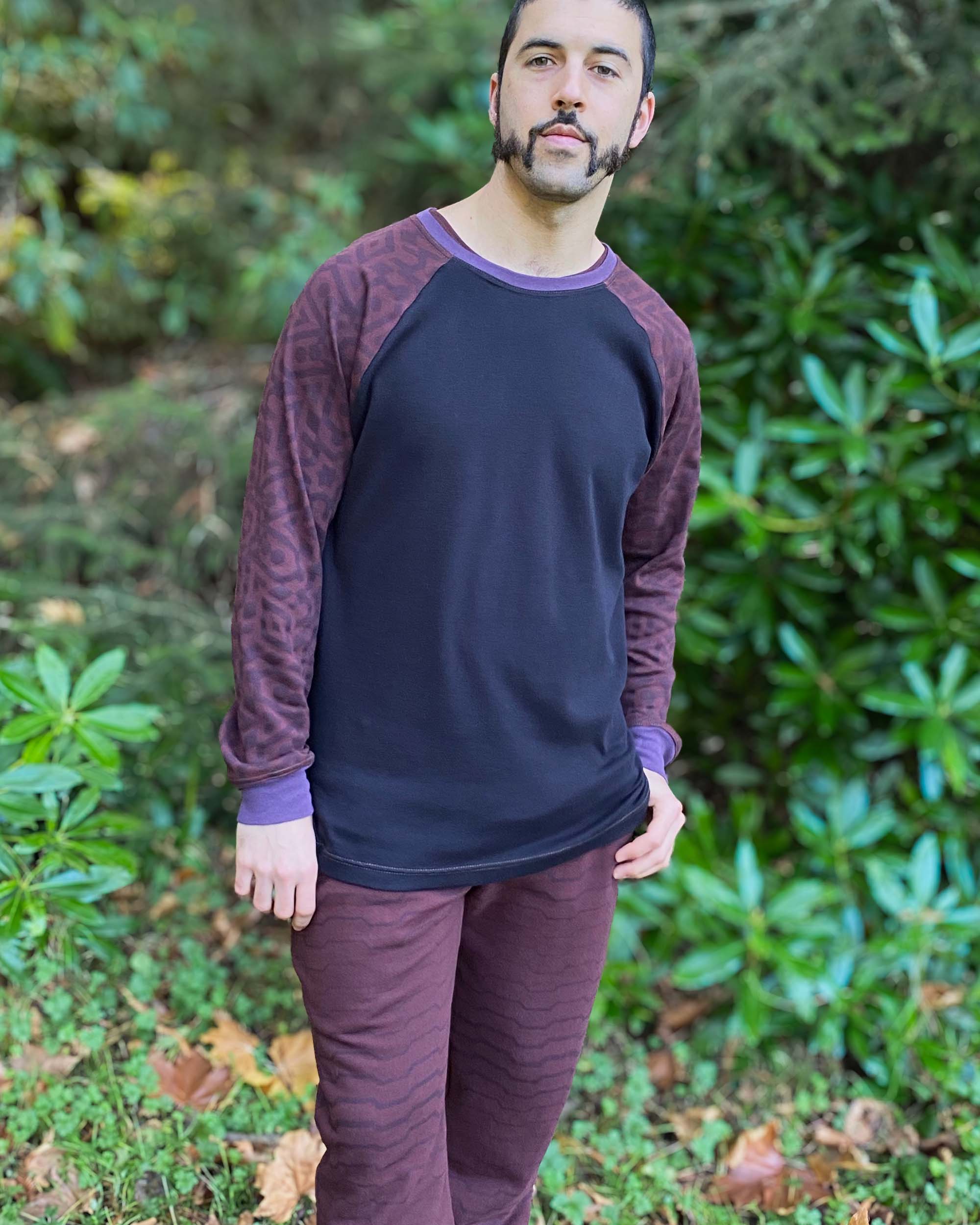 Organic cotton long sleeve shirt, black with brown accent fabric, front view on male model.