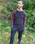 Organic cotton long sleeve crew neck, black with brown geometric accent fabric, front view on male model.
