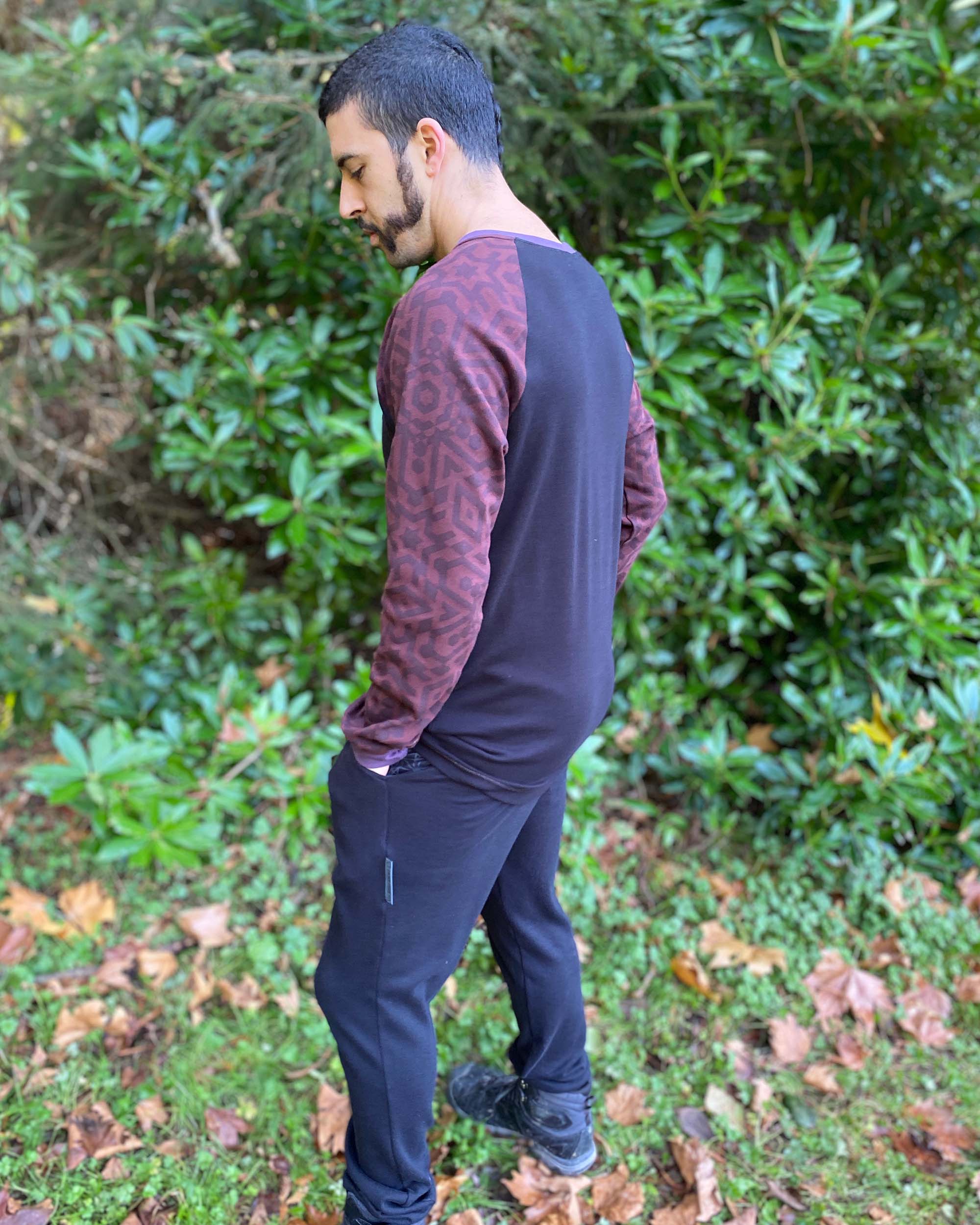 Organic cotton long sleeve shirt, black with brown geometric accent fabric, left side view on male model.