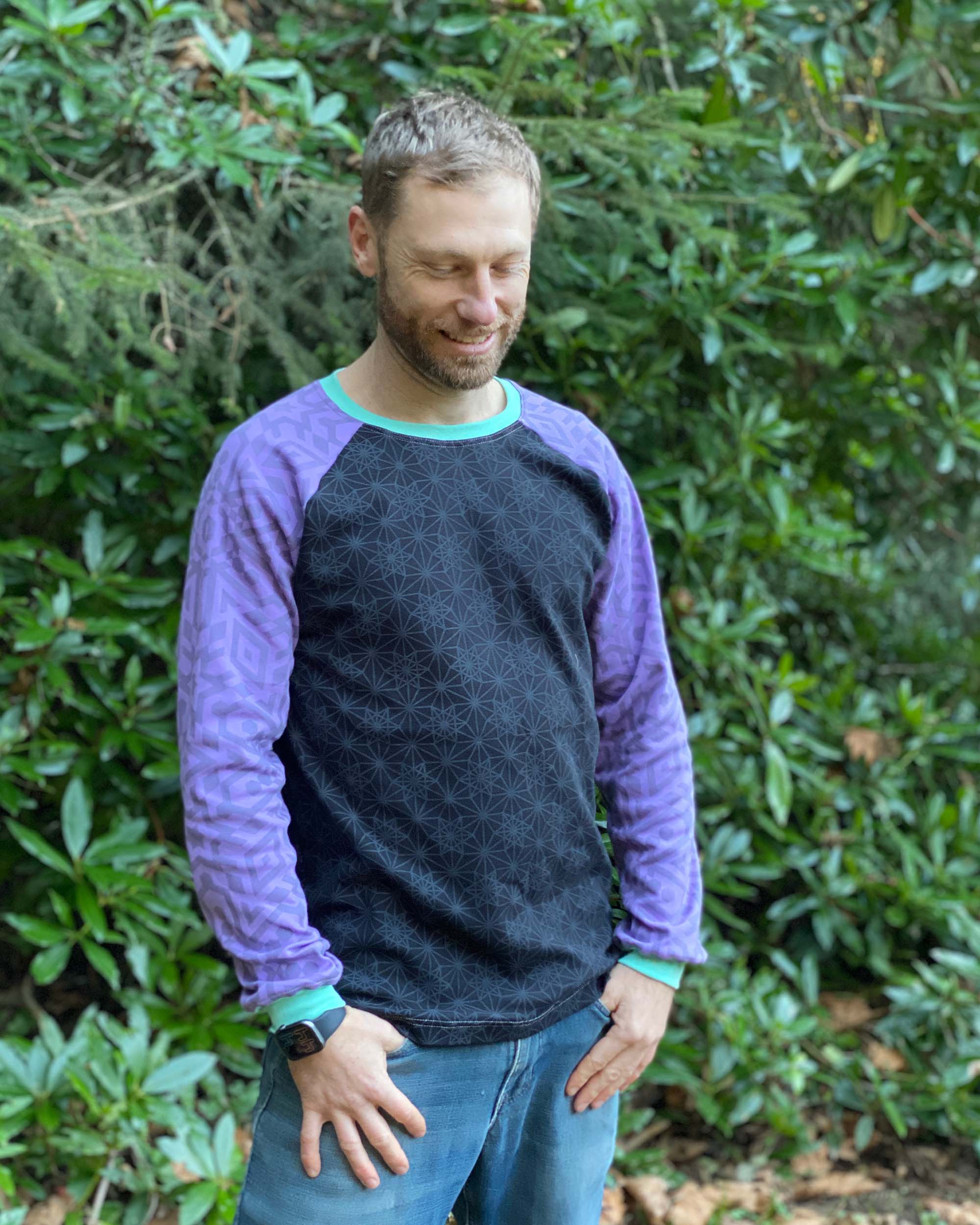 Organic cotton long sleeve shirt, black with lavender accent fabric, front view on model.