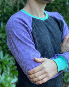 Organic cotton long sleeve shirt, black with lavender geometric sleeve print, detail view of sleeves.