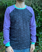 Organic cotton long sleeve shirt, black with lavender geometric sleeves, front view on male model.