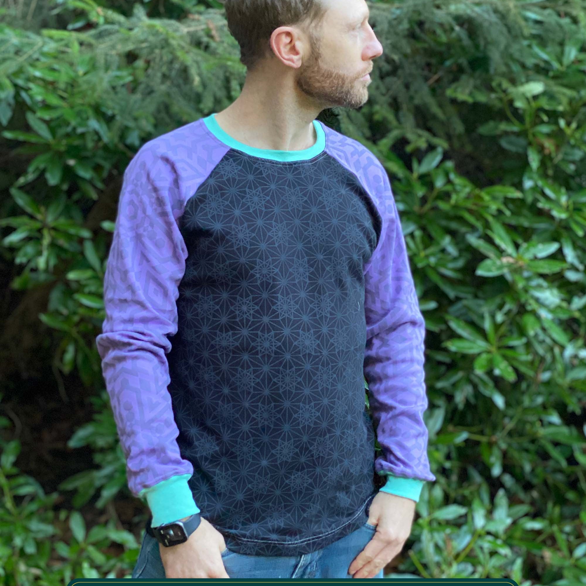 Organic cotton long sleeve shirt, black with lavender geometric sleeve print, front view on model.
