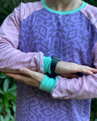 Organic cotton long sleeve shirt, lavender with pink geometric striped sleeves, detail view of sleeves.
