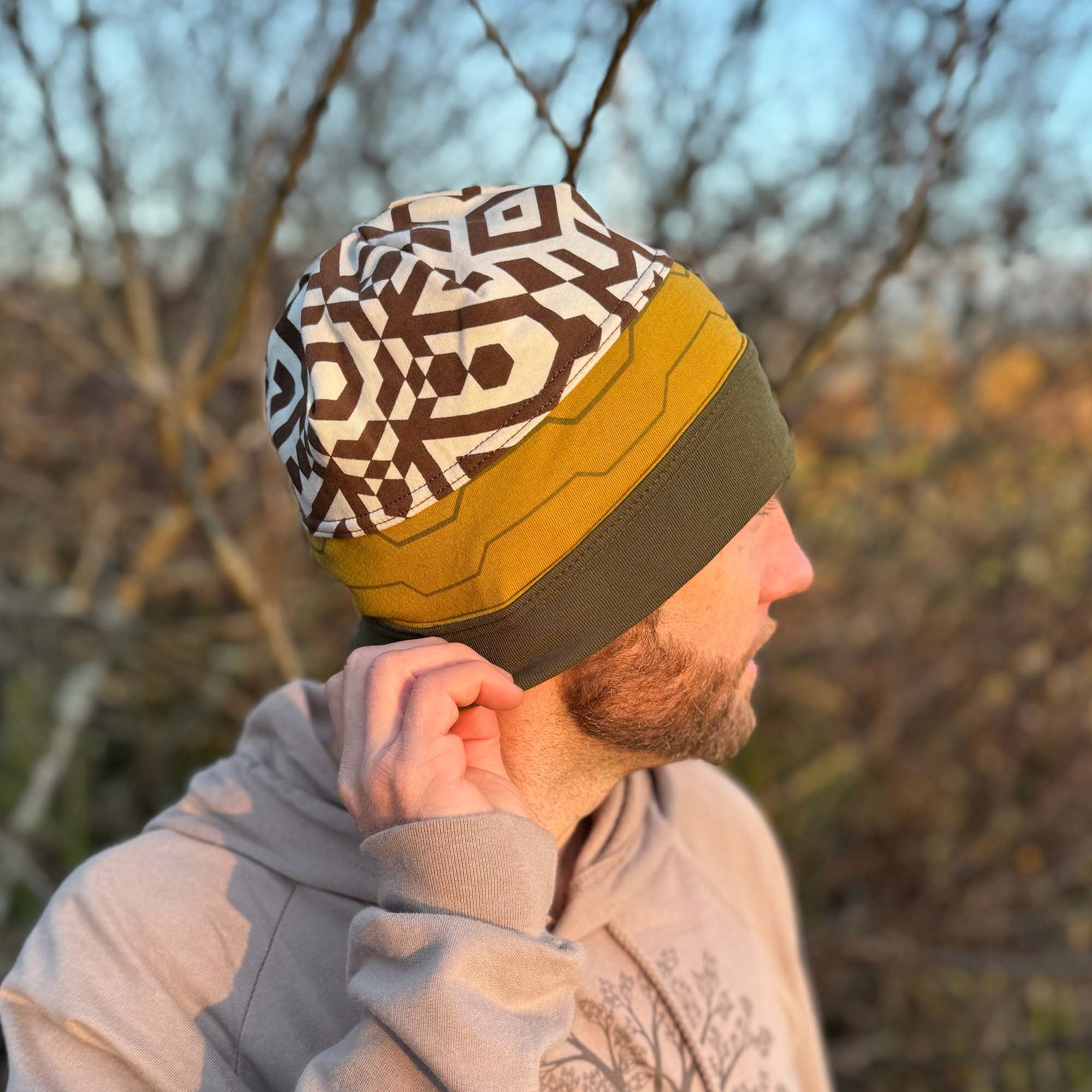 Organic cotton beanie, undyed, yellow and green colored fabric, right side on male model.