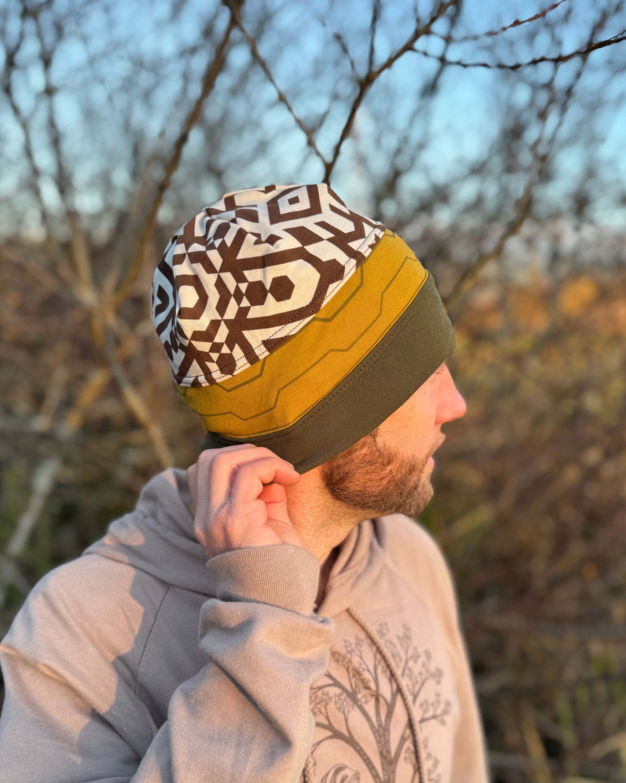 Organic cotton beanie, undyed, yellow and green colored fabric, right side on male model.