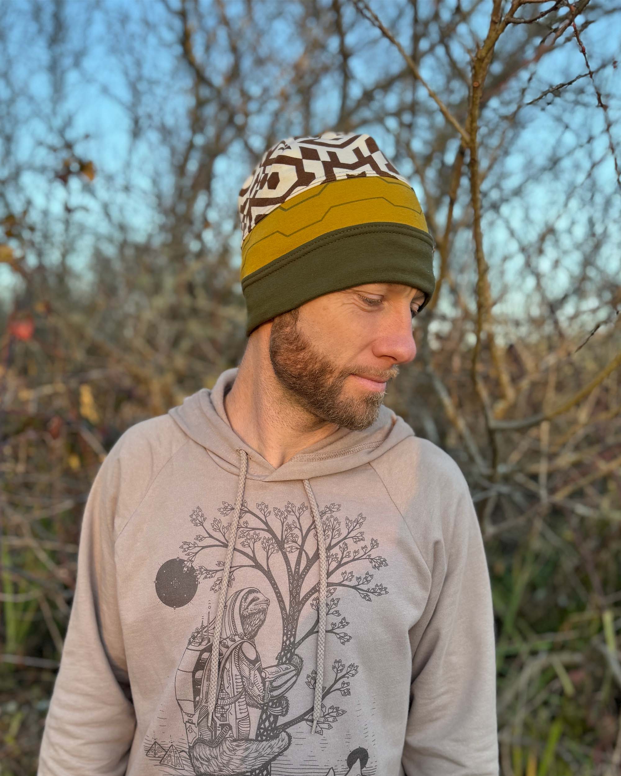 Organic cotton beanie, undyed, yellow and green accent fabric, right side on male model.