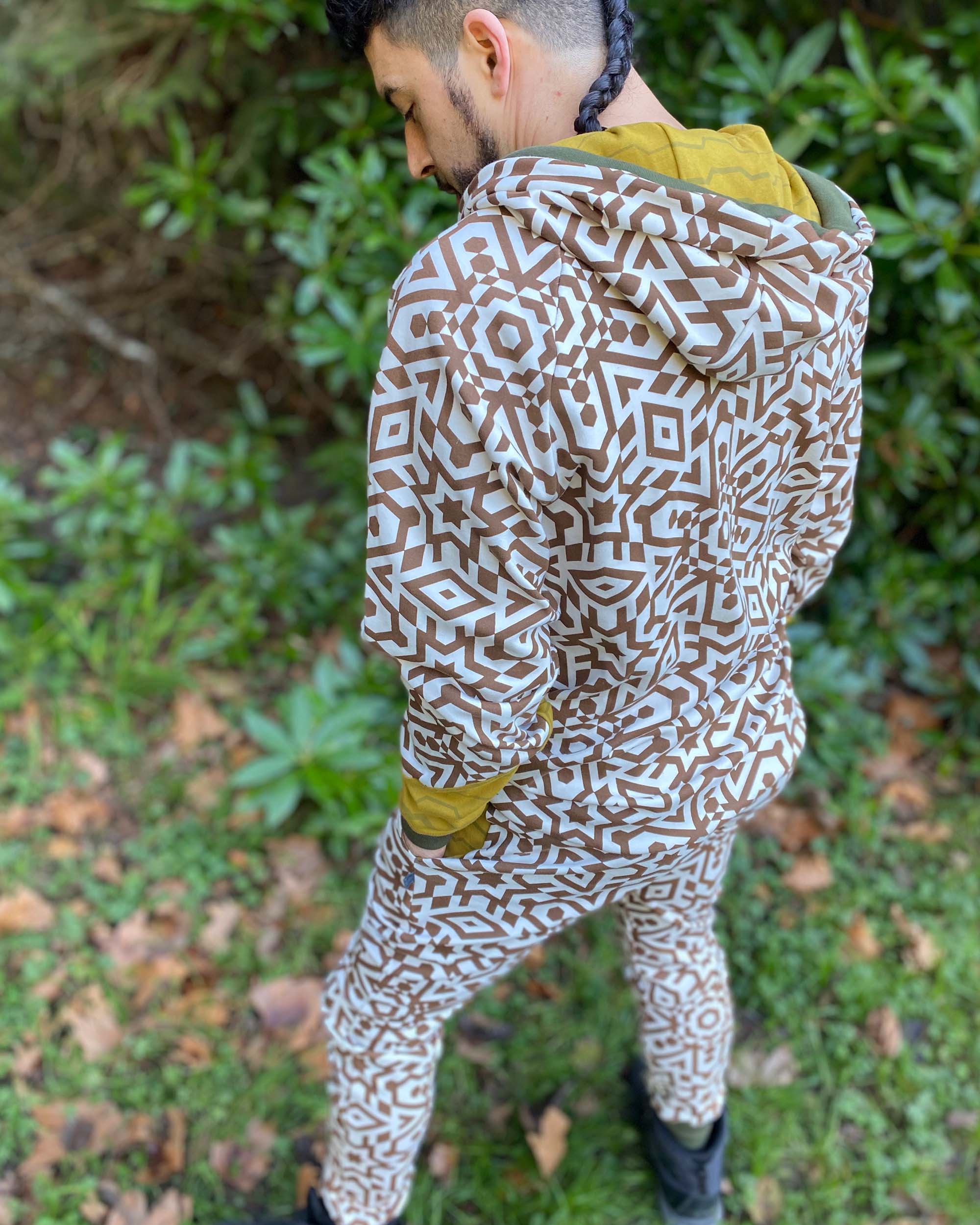Men's matching two piece sweatsuit, brown geometric organic fabric print, back view, worn on male model.