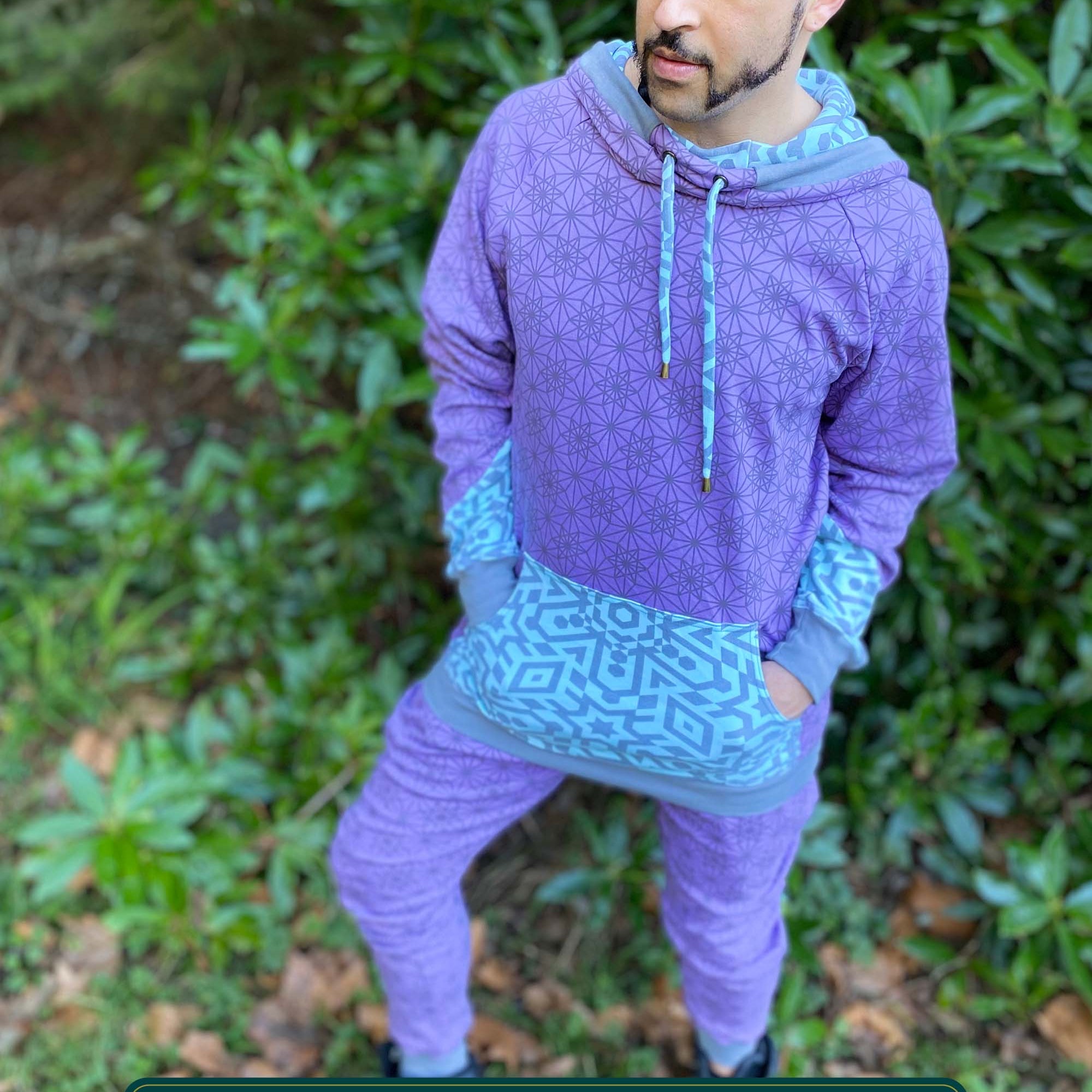 Men's matching two piece sweatsuit, lavender fabric and geometric print, front view worn by male model.