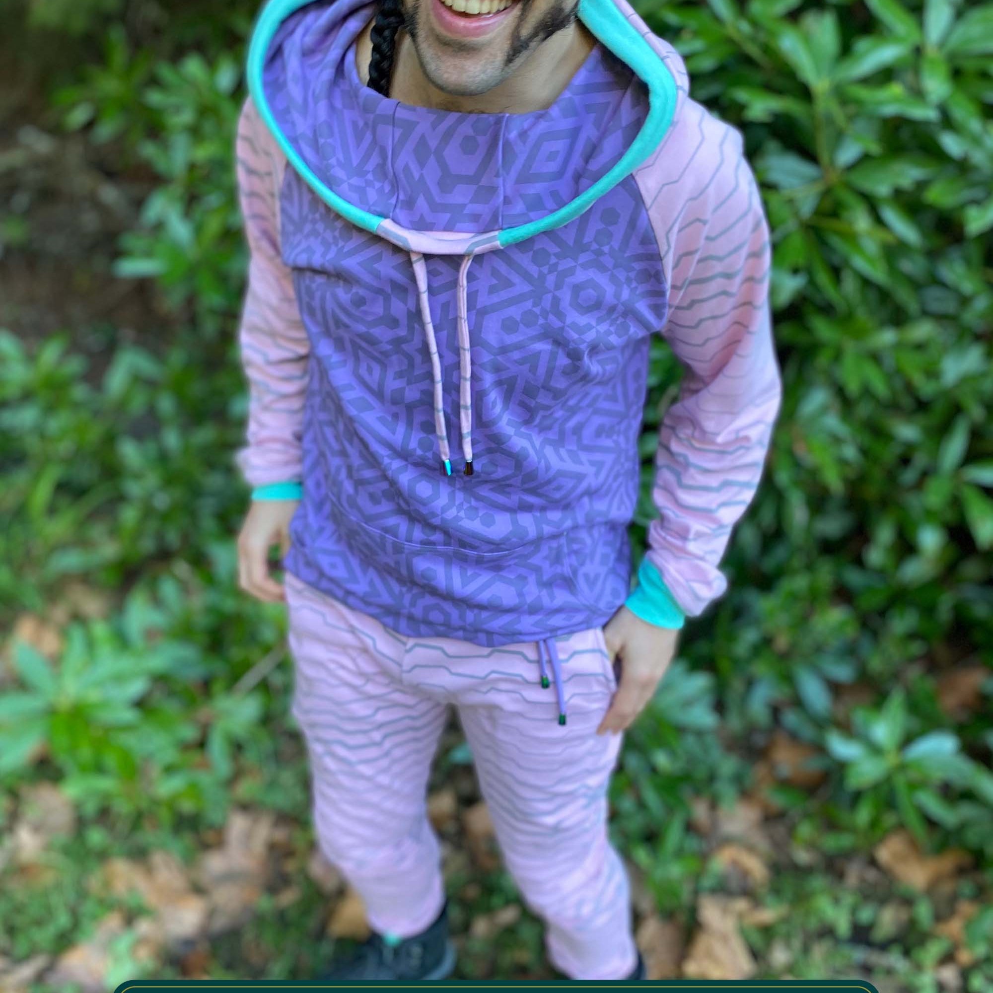 Men's matching two piece sweatsuit, pink and purple geometric printed fabric, front view on model.