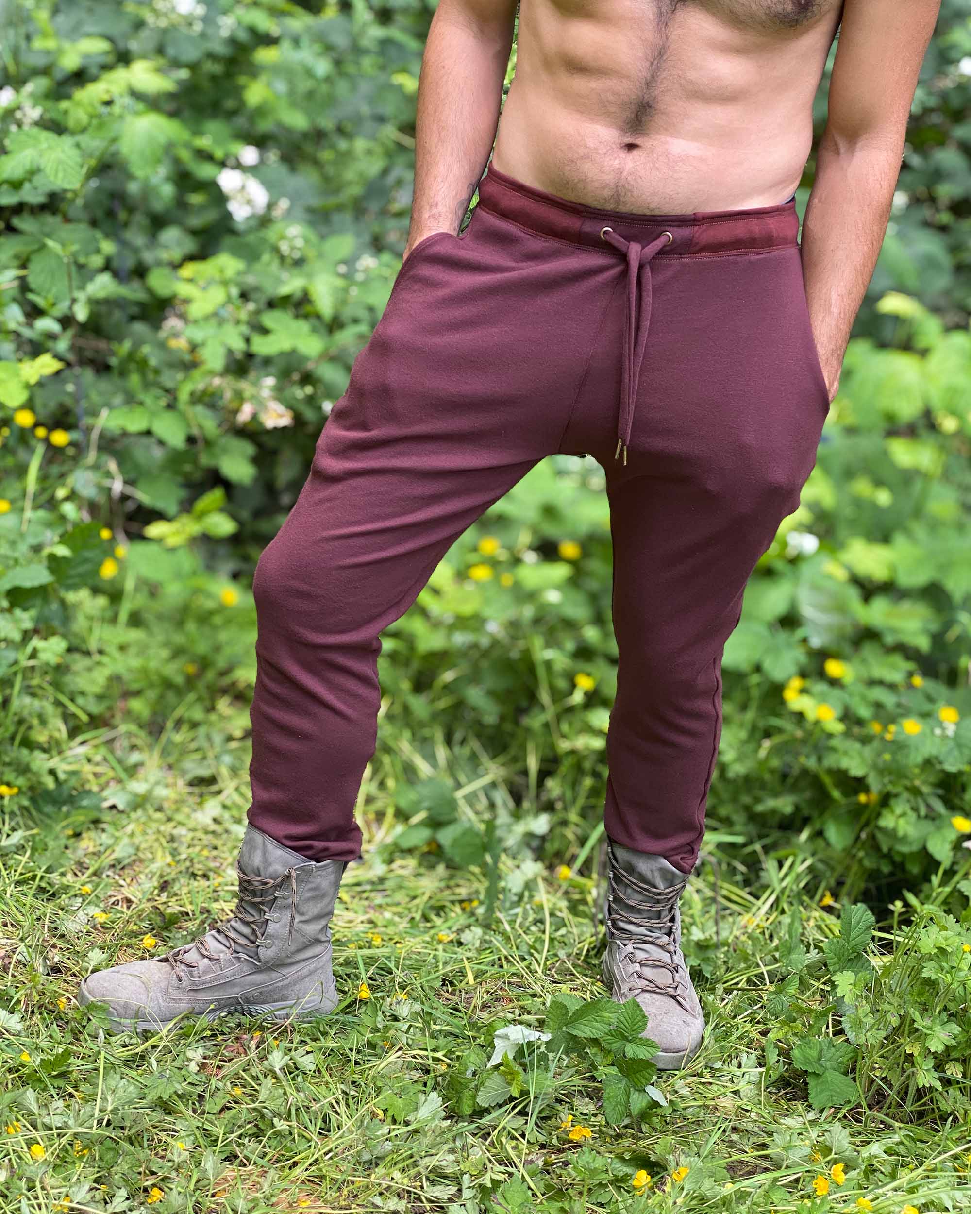 Organic cotton unisex joggers, reddish brown fabric, front view on male model.