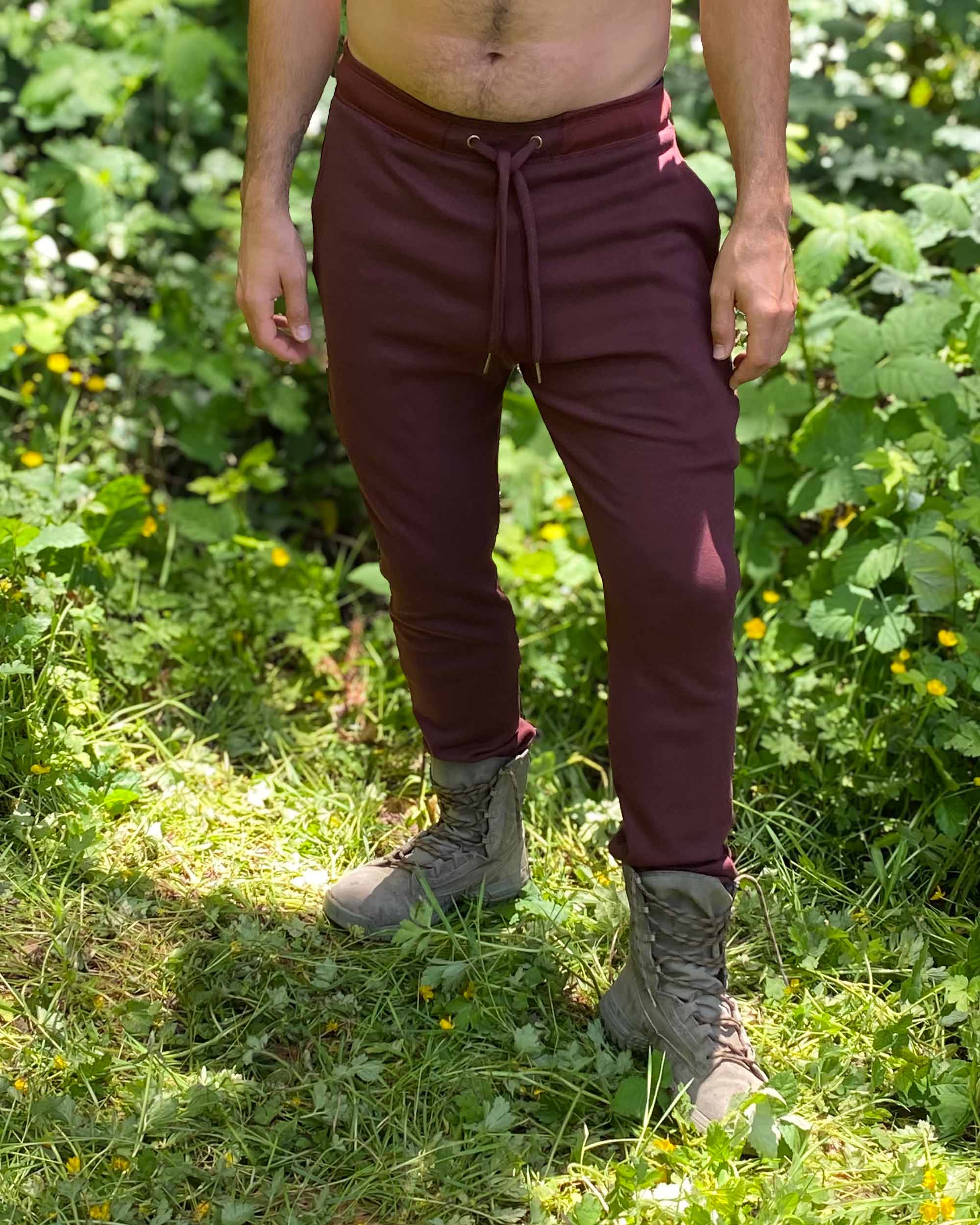 Organic cotton unisex joggers with drawcord, reddish brown fabric, front view on male model.